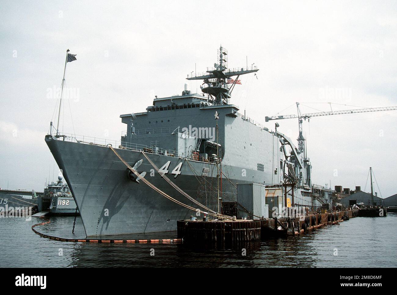 The dock landing ship USS GUNSTON HALL (LSD44) lies tied up to a pier