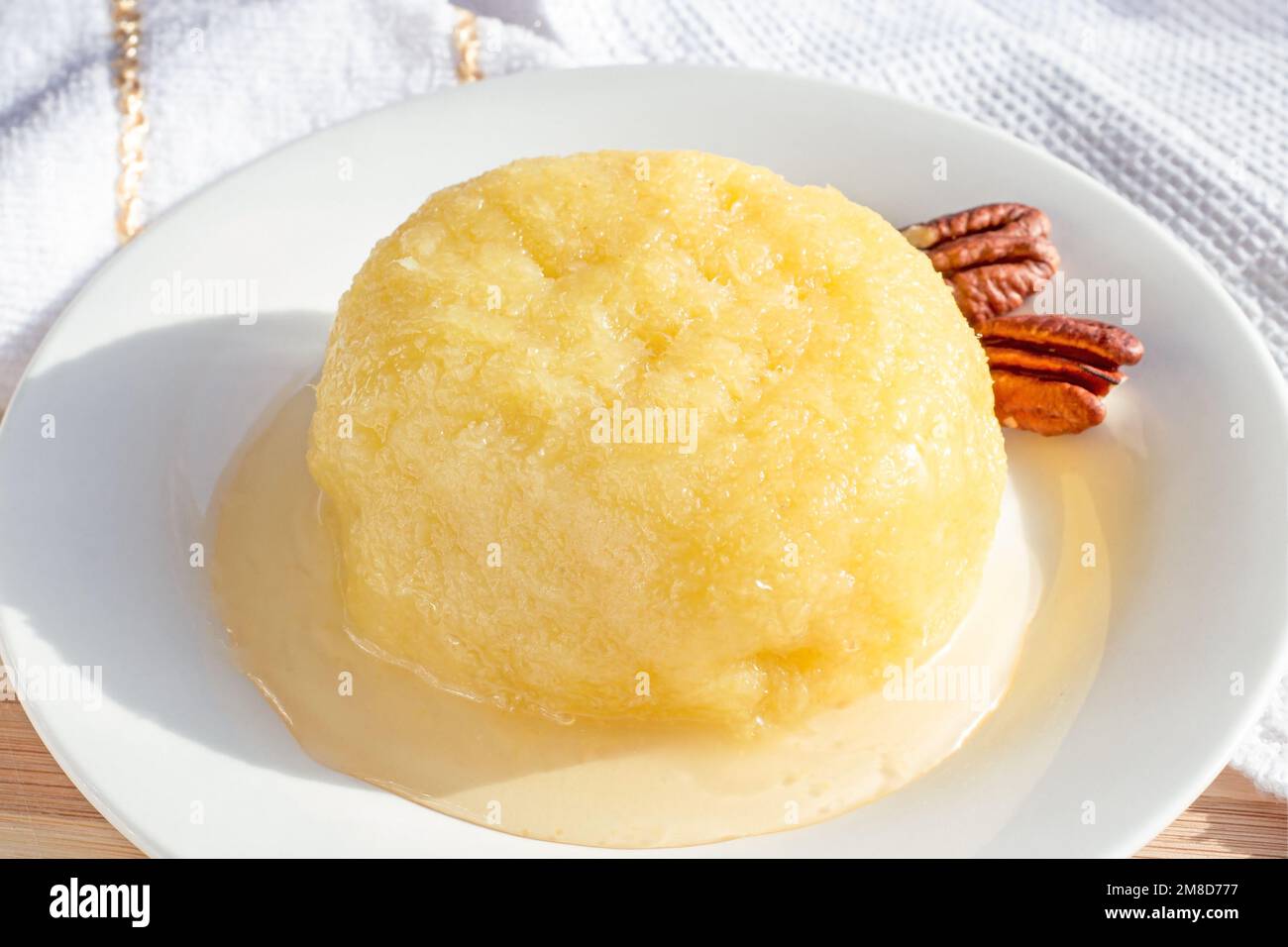 Sweet yellow Turkish dessert cheese halva Hosmerim on the white plate
