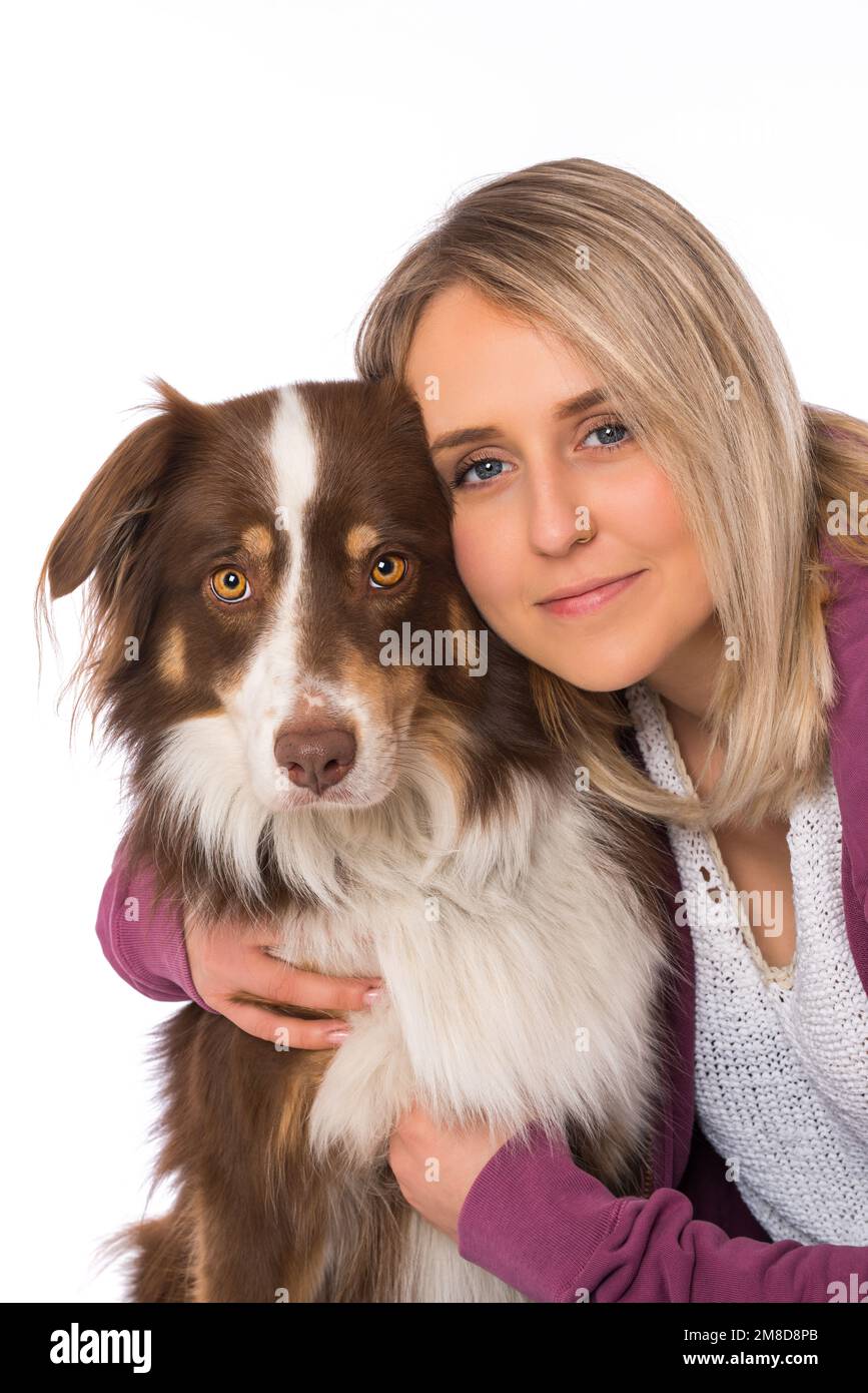 Young woman with australian shepherd dog on white background Stock
