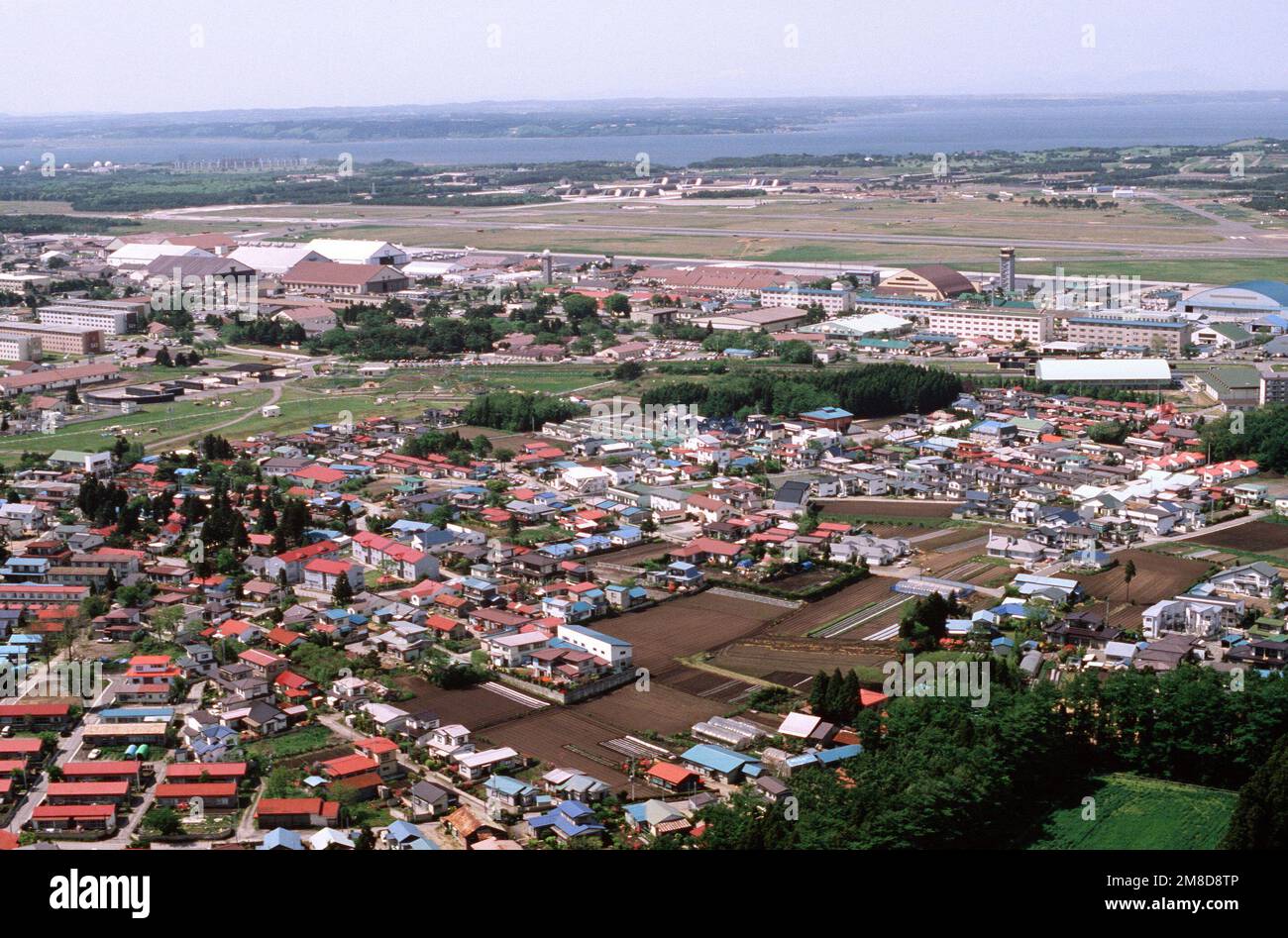 An aerial view of a portion of the base and the surrounding city of