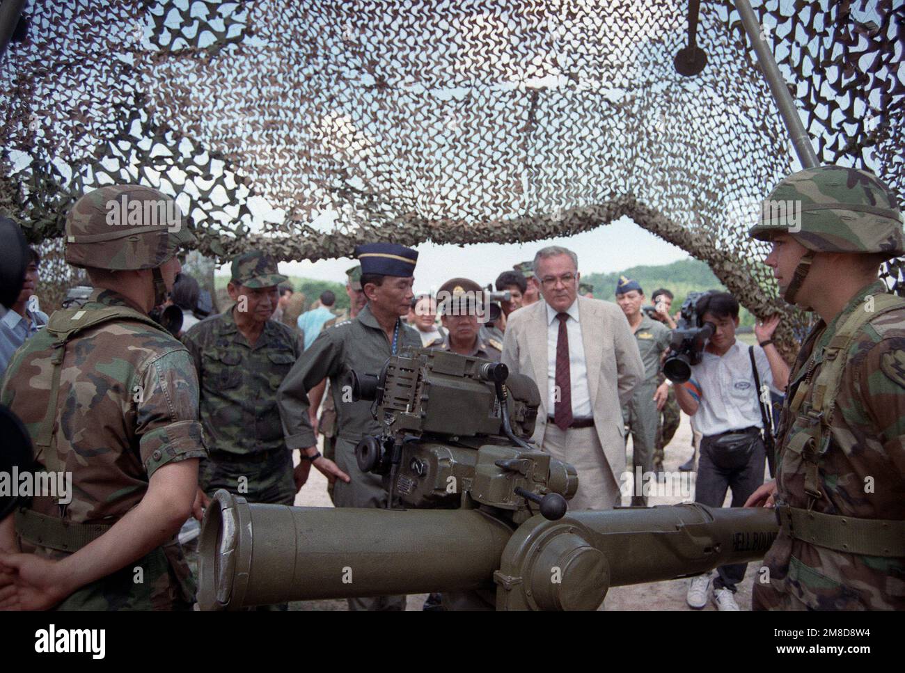 GEN Sundhara Kongsompong, left center, Supreme Commander, Royal Thai Armed Forces, and U.S. Ambassador to Thailand Daniel A. O'Donohue, center right, view a TOW tube-launched, optically tracked, wire-guided heavy anti-tank weapon at a static display manned by members of 4th Bn., 22nd Inf., 25th Inf. Div. (Light), following the opening ceremonies for the combined Thai/U.S. exercise Cobra Gold '90. Subject Operation/Series: COBRA GOLD '90 Base: Chon Buri Country: Thailand (THA) Stock Photo