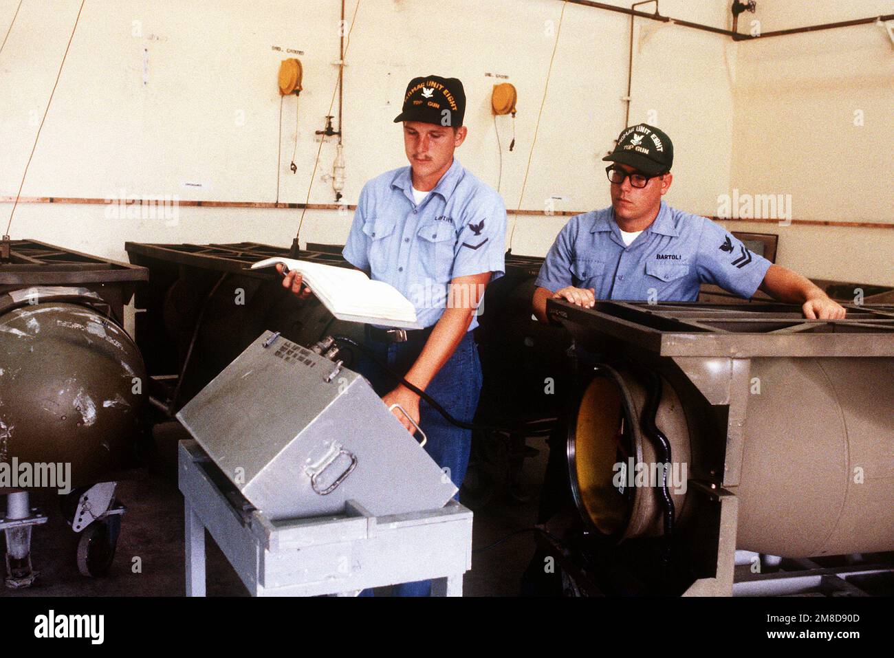 Mineman 3rd Class William H. Lowry and Mineman 2nd Class Anthony Bartoli, Mobile Mine Assembly Group Unit 8, test and MK-55 bottom mine before transferring it to the U.S. Air Force for a joint Air Force-Navy exercise. Country: United States Of America (USA) Stock Photo