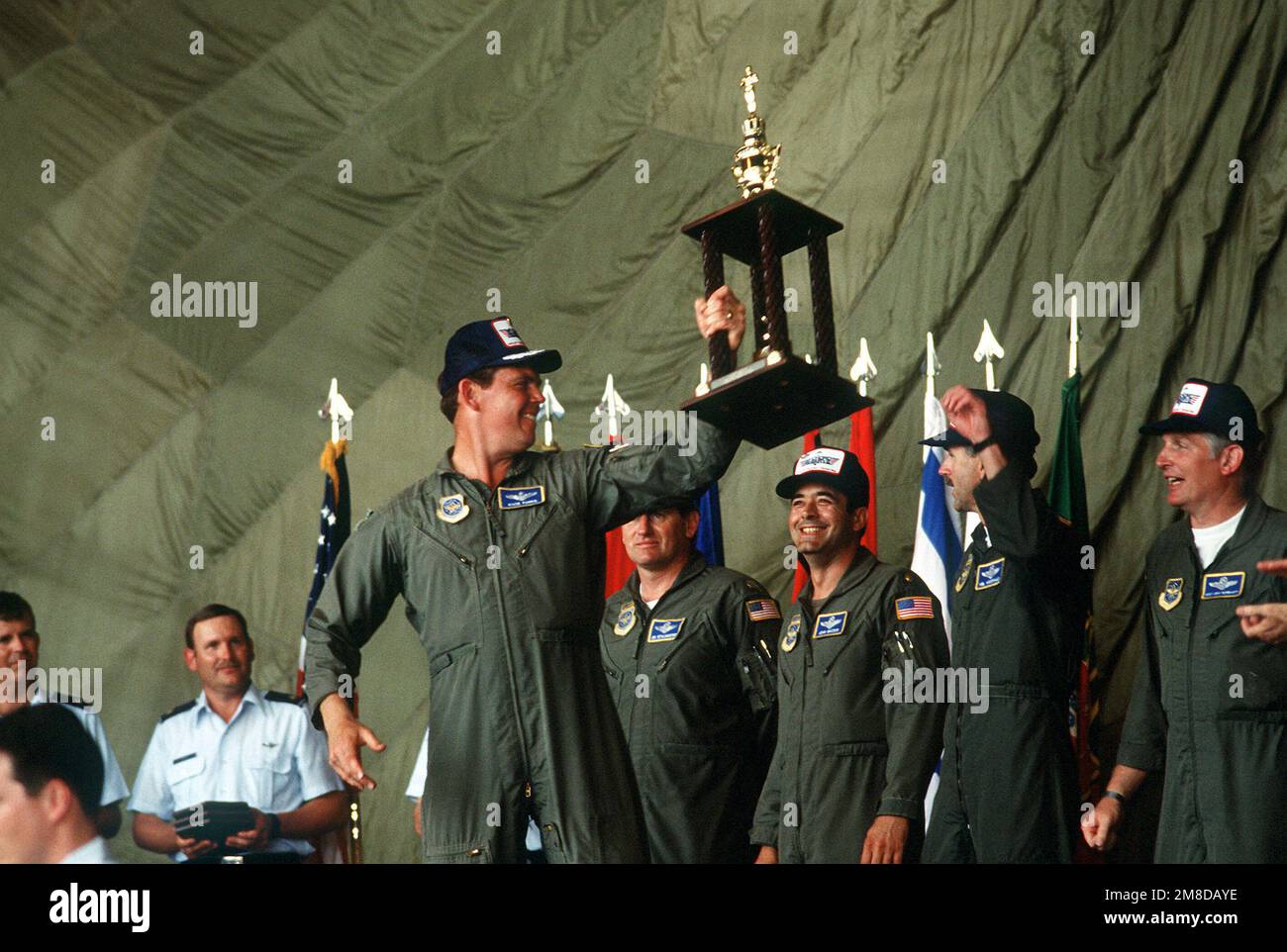 MAJ I. Clontz, team chief for the 145th Tactical Airlift Group (TAG) of the North Carolina Air National Guard, proudly hoists the trophy his team won for best United States team for Airlift Rodeo '90. The 145th TAG, representing the 123rd Tactical Airlift Wing of Standiford Field, KY, placed third in the Best Overall category. Airlift Rodeo is an annual airdrop competition that tests the flight and ground skills of military Airlift Command aircrews as well as foreign teams.. Base: Pope Air Force Base State: North Carolina(NC) Country: United States Of America(USA) Stock Photo