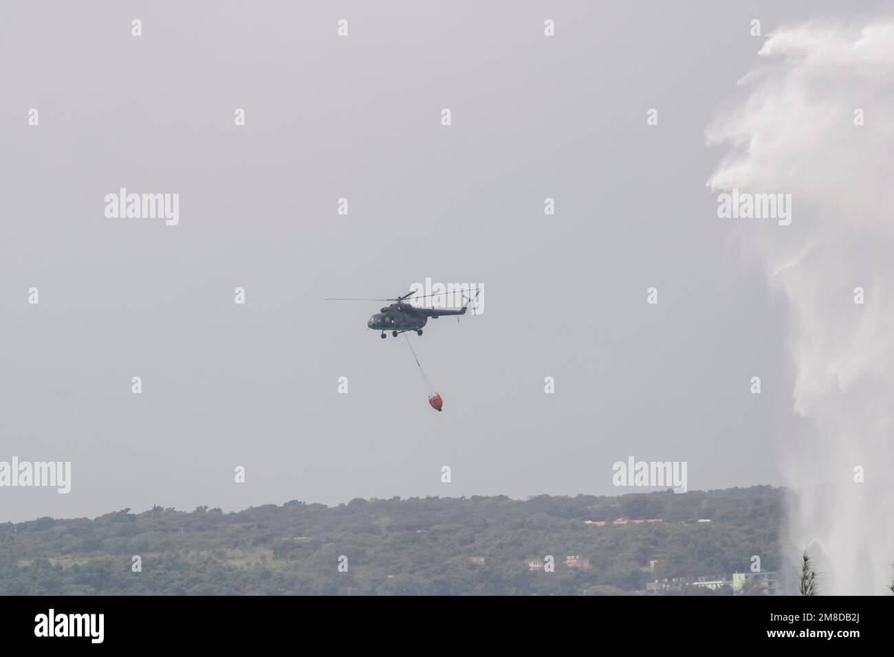The Cuban armed forces helicopter putting out the fire from the