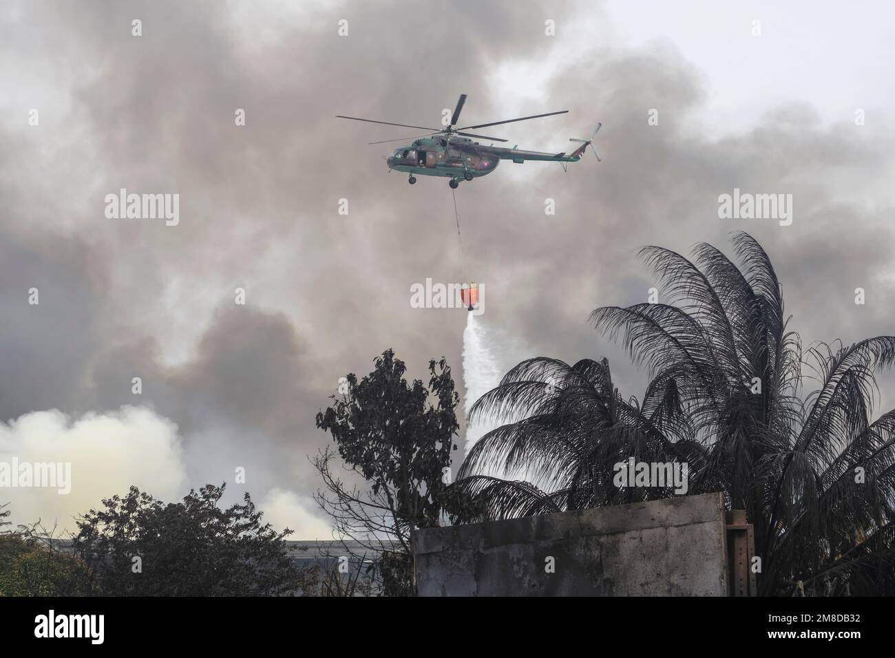 The Cuban armed forces helicopter putting out the fire from the