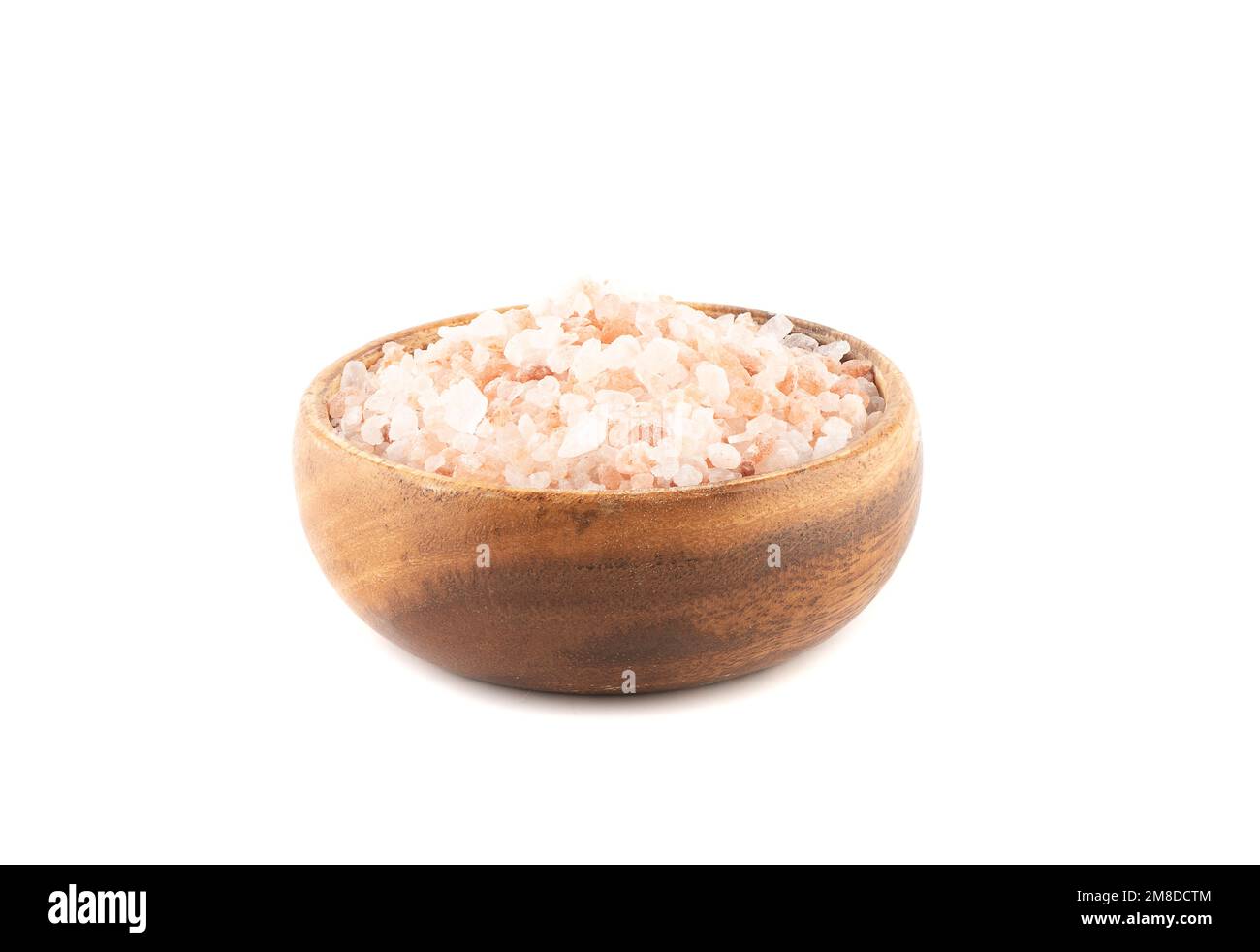 Wooden bowl with large pink Himalayan salt on a white background. Copy space. Stock Photo