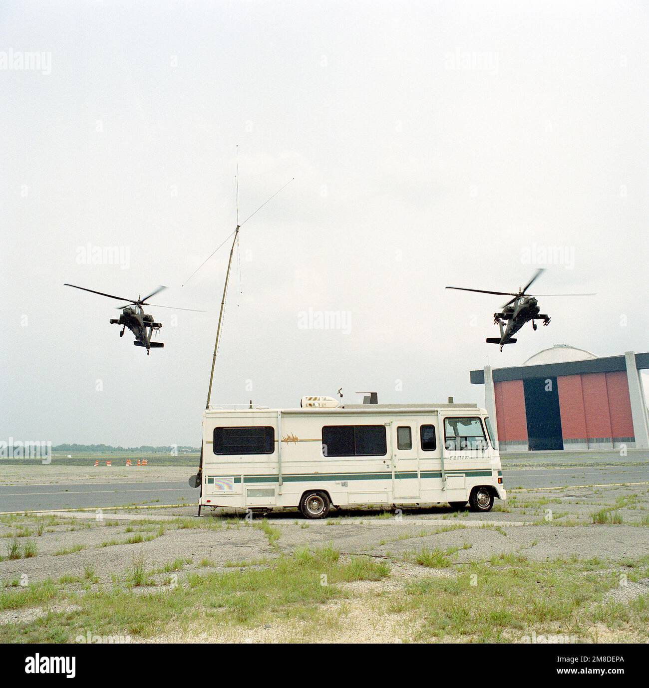 AH64 Apache helicopters hover near an Avionics Research and