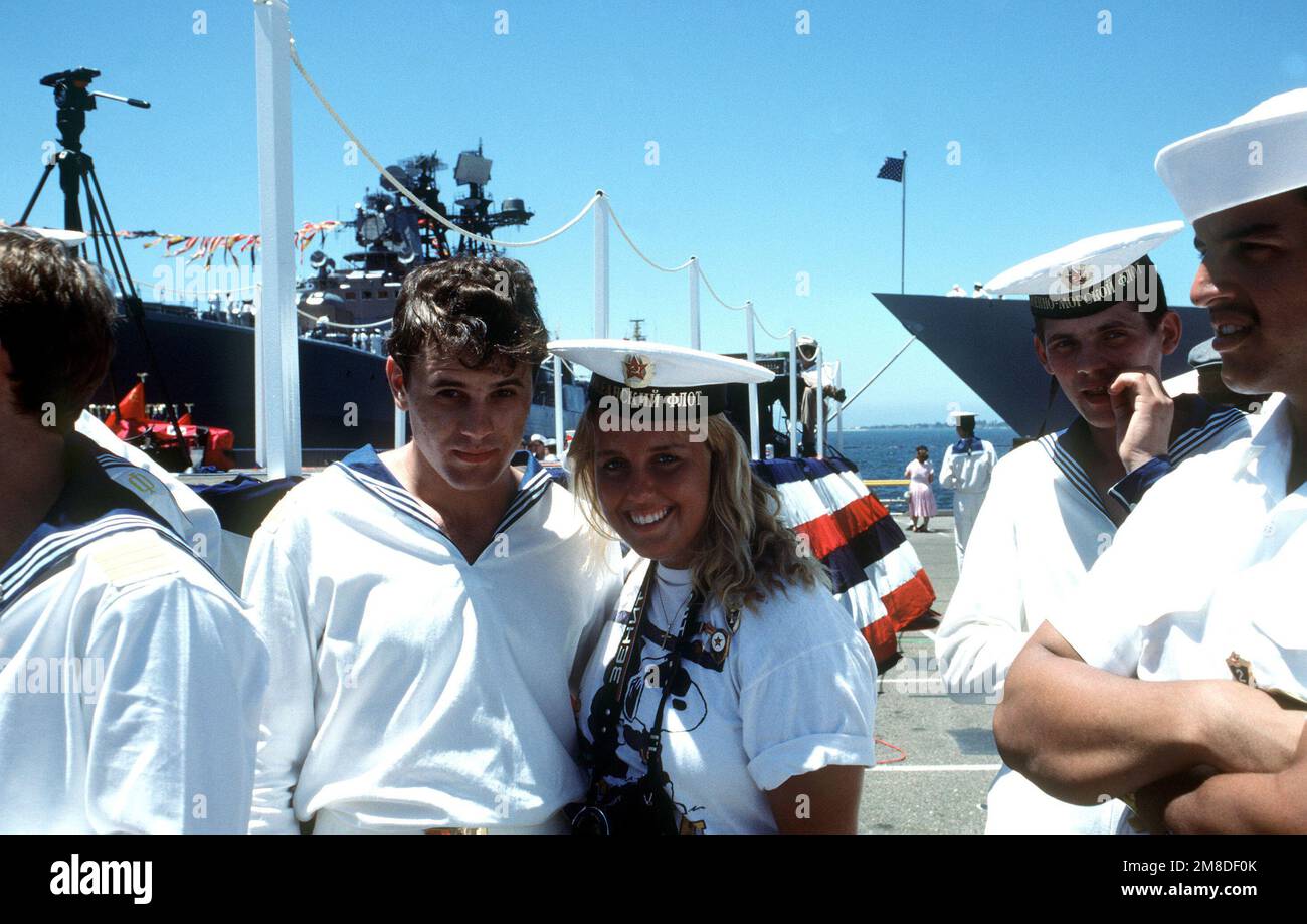 A woman poses with a Soviet sailor on the pier during a fiveday