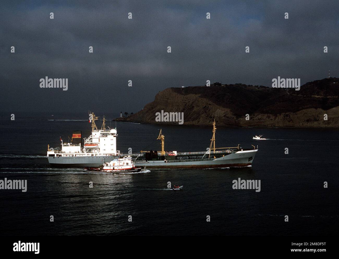 A commercial harbor tug escorts the Soviet Kaliningradneft class support  tanker ARGUN past Point Loma as the vessel makes its way toward Naval  Station, San Diego. The ARGUN, along with the Udaloy