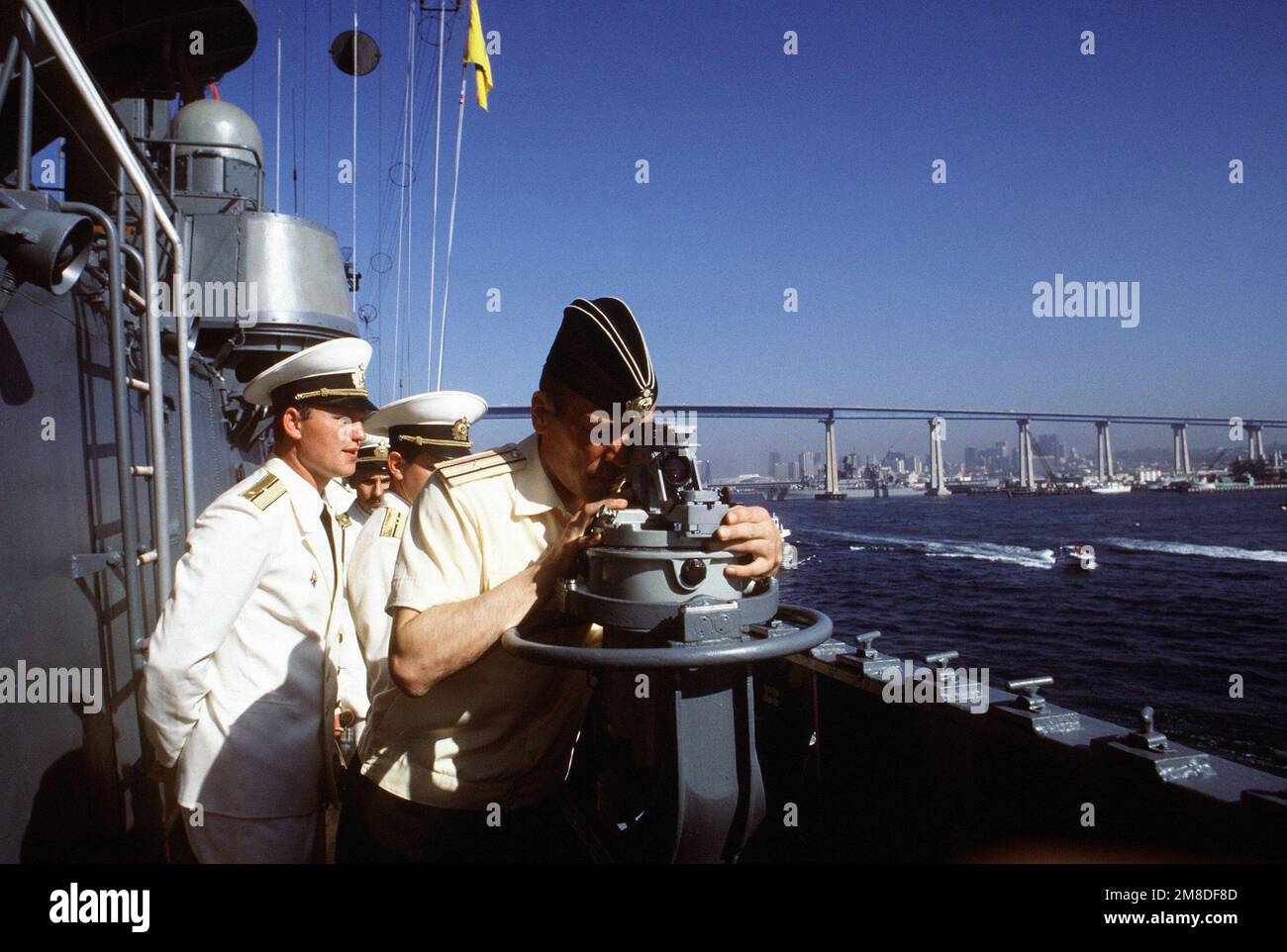 An officer takes a bearing with a telescopic alidade as his ship, one of the three Soviet vessels to visit Naval Station, San Diego, nears port. The Udaloy class destroyer ADMIRAL VINOGRADOV, the Sovremenny class destroyer BOYEVOY and the Kaliningradneft class support tanker ARGUN are arriving at the station for a four-day, goodwill visit. Base: San Diego State: California (CA) Country: United States Of America (USA) Stock Photo