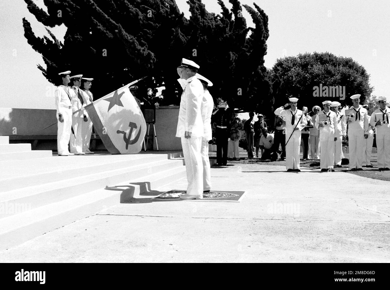 ADM Charles R. Larson, commander in chief, U.S. Pacific Fleet, and ADM Gennadiy Khvatov, commander, Soviet Pacific Fleet, salute during a wreath-laying ceremony at Fort Rosecrans National Cemetery. The ceremony is being held to honor those members of the U.S. Merchant Marine who died while delivering supplies to the Soviet Union during World War II. Three ships of the Soviet Pacific Fleet are in San Diego for a five-day goodwill visit. Base: San Diego State: California (CA) Country: United States Of America (USA) Stock Photo