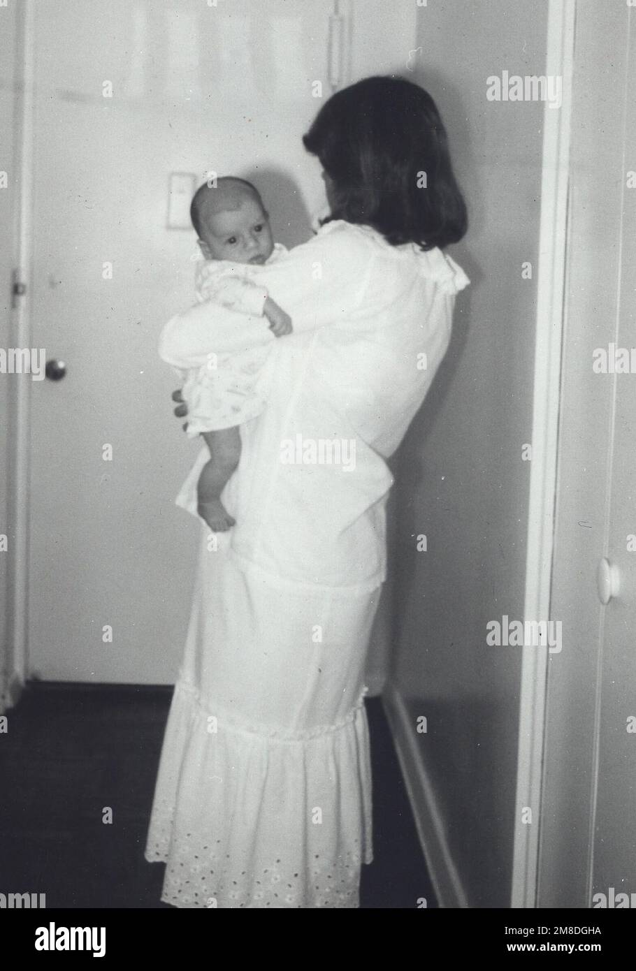 Circa 1968, Memphis, Tennessee, USA: Actress and wife of Elvis, PRISCILLA PRESLEY dressed in white holding her new baby daughter LISA MARIE PRESLEY. (Credit Image: © Globe Photos/ZUMA Wire) EDITORIAL USAGE ONLY! Not for Commercial USAGE! Stock Photo