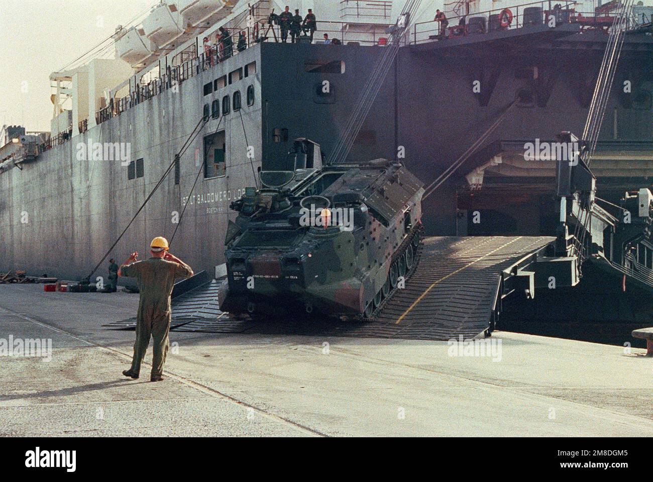 A Marine drives an AAVP-7A1 amphibious assault vehicle down the stern ...