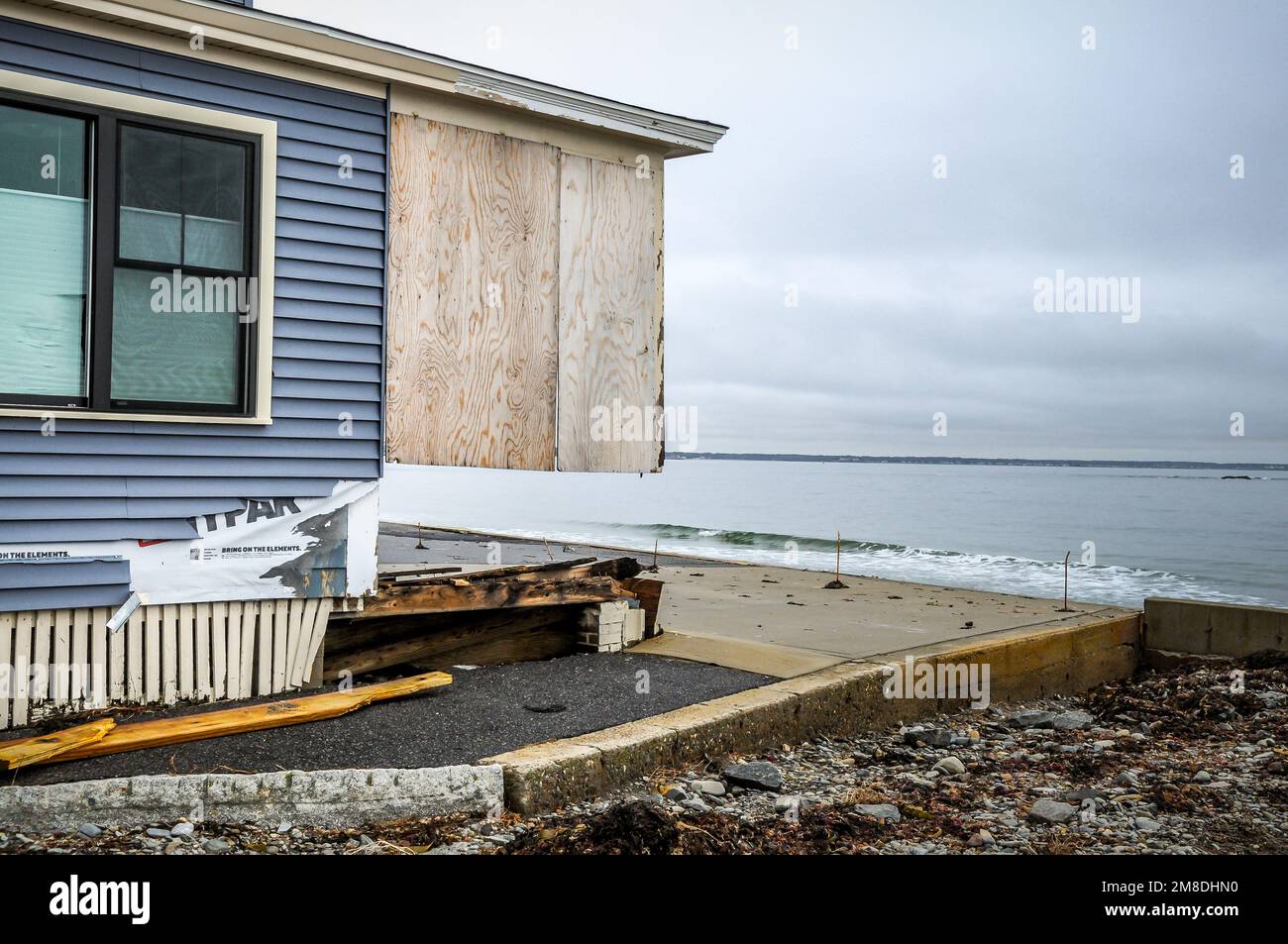 The first major storm of the year lasted for two days, and washed away part of this home. It hit so hard that it took most of the wood  out to sea. Stock Photo