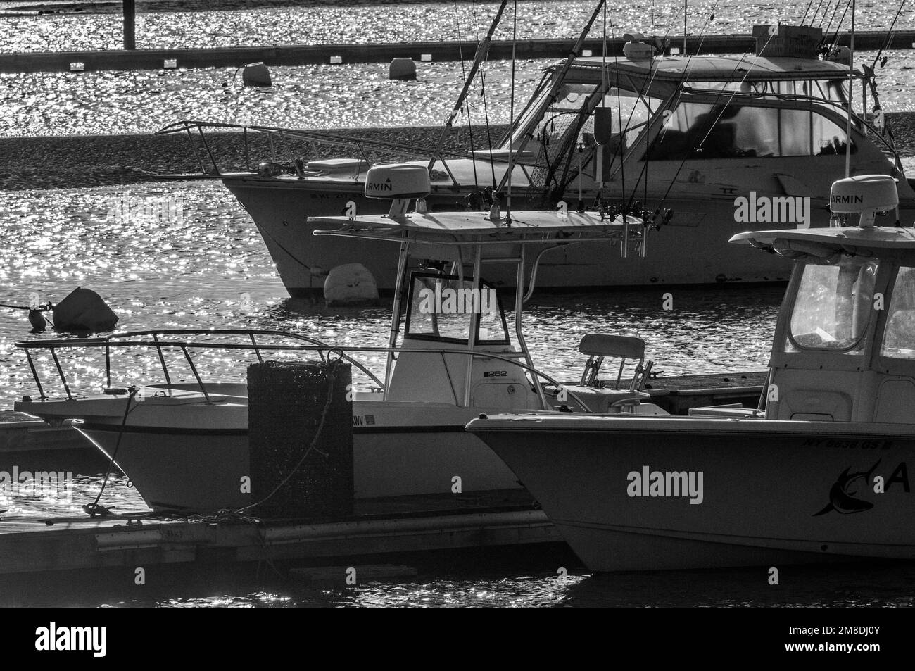 Three boats moored for the winter on this cold winter day. But in three months, all these docks will be full with boats for the next eight months. Stock Photo