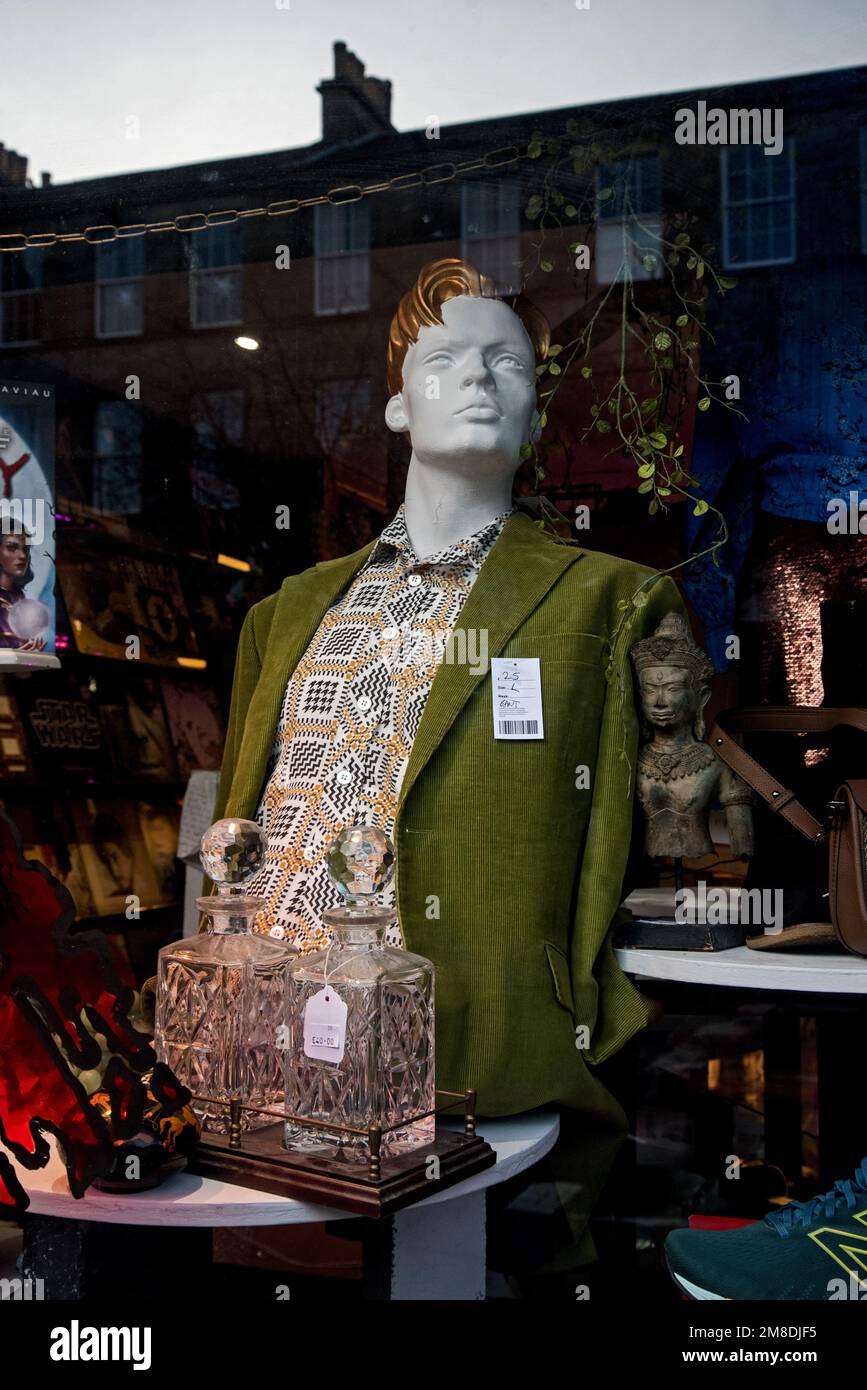 Mannequin and reflections in the window of a Shelter charity shop in Stockbridge, Edinburgh, Scotland, UK. Stock Photo