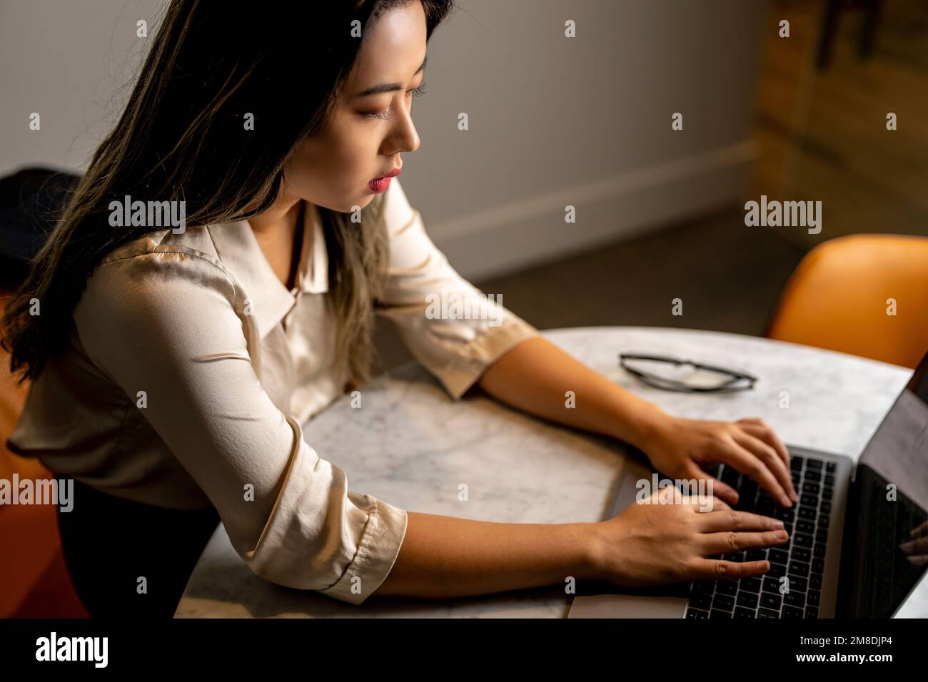 Business Woman - Top Down - Software Engineer Working on Laptop in Conference Room Stock Photo