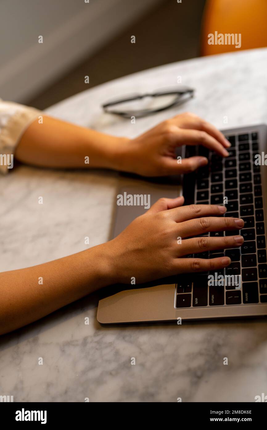 Young Woman's Hands on Laptop Keyboard in a Conference Room Stock Photo