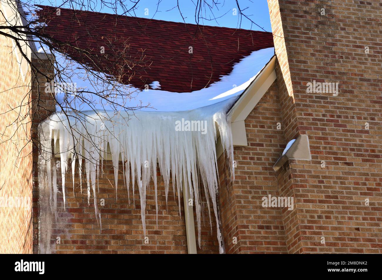 Icicles hang on a house roof. Snow melt from house roof warm winter day  27015686 Stock Photo at Vecteezy