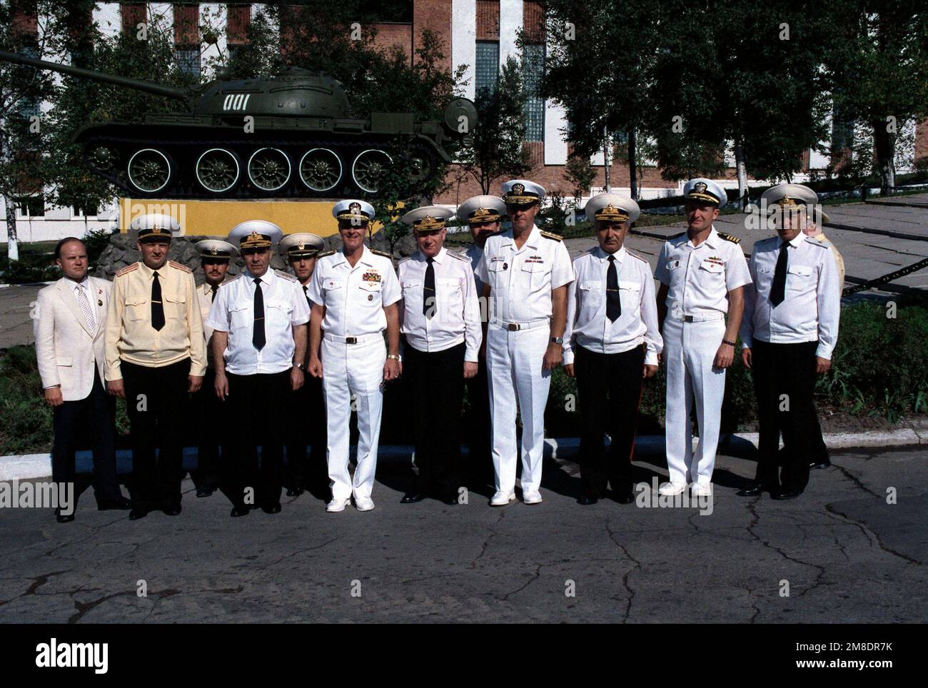 Admiral Gennadi Khvatov, front row, third from left, Commander, Soviet Pacific Fleet, Admiral Charles R. Larson, front row, fourth from left, Commander in CHIEF, US Pacific Fleet, and other US and Soviet officers Soviet officers gather in front of a T-54 tank at a Soviet navy service school during a visit to the city by two US Navy ships. The guided missile cruiser USS PRINCETON (CG-59) and the guided missile frigate USS REUBEN JAMES (FFG 57) are in Vladivostok for four days as part of a goodwill exchange program. Base: Vladivostok State: Siberia Country: U.S.S.R. (SUN) Stock Photo