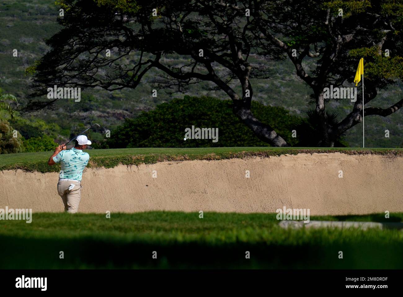 Gary Woodland hits from the bunker on the 10th green during the second