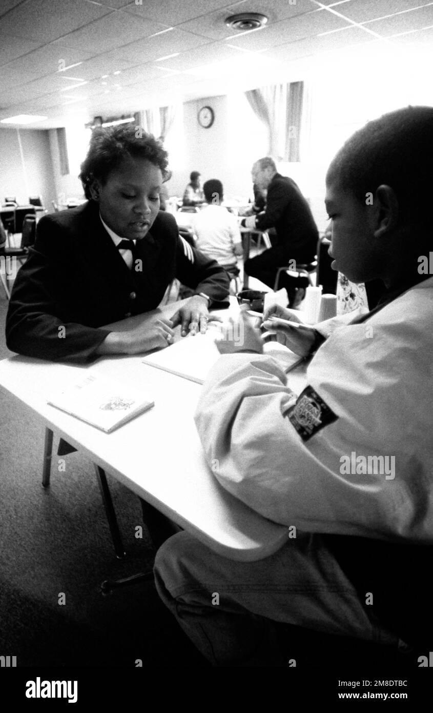 SEAMAN Anderson, Naval Military Personnel Command, tutors an inner city minority student in the 'Navy Kids' program. Base: Washington State: District Of Columbia (DC) Country: United States Of America (USA) Stock Photo