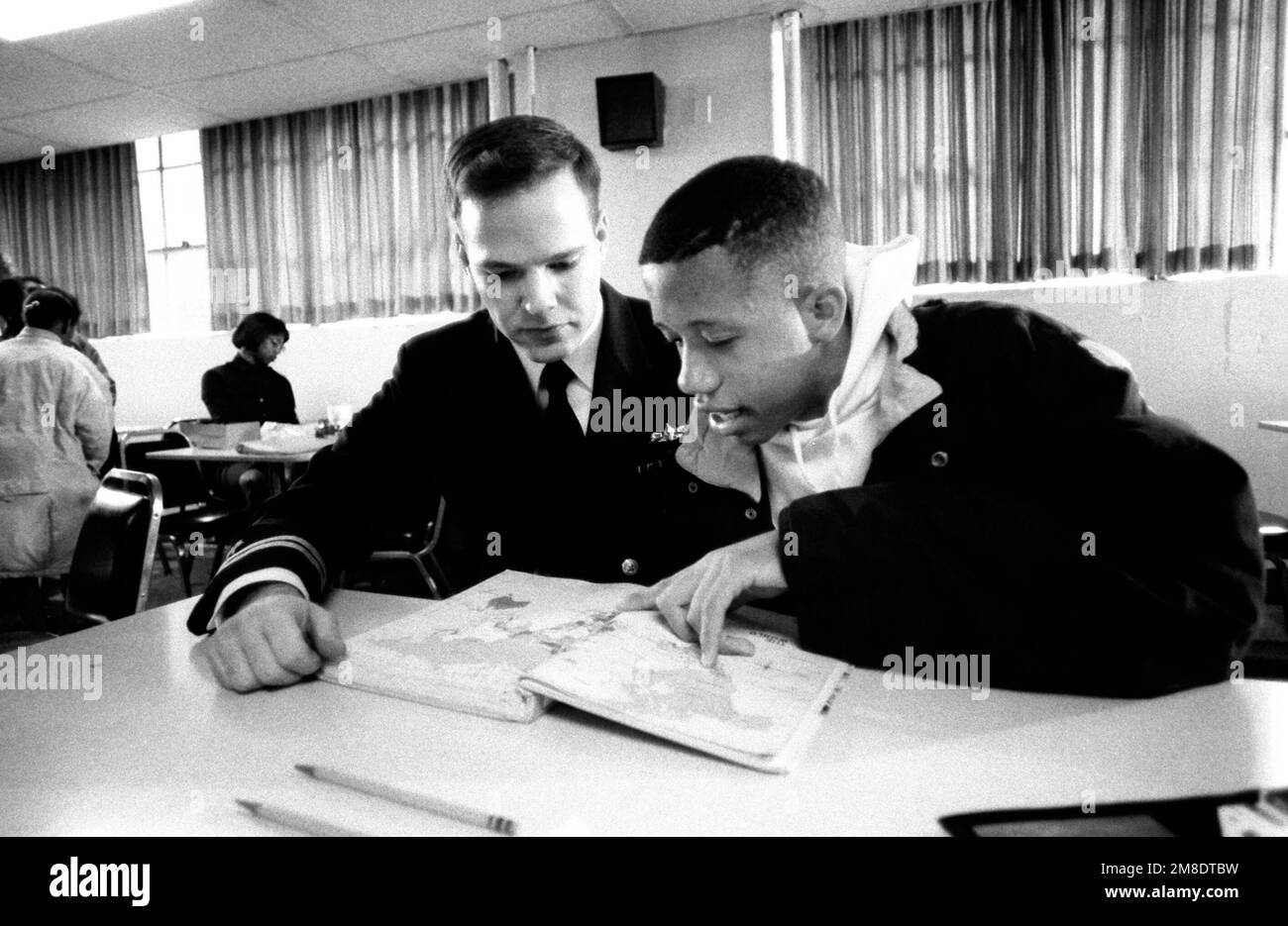 Lieutenant Gus M. Ventura, Naval Military Personnel Command, tutors an inner city minority student in the 'Navy Kids' program. Base: Washington State: District Of Columbia (DC) Country: United States Of America (USA) Stock Photo