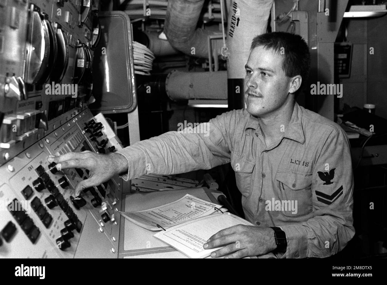 Gas Turbine Systems Technician E (Electrical) 2nd Class David Lewis stands watch at a console in central control aboard the guided cruiser USS CHANCELLORSVILLE (CG 62). Country: Unknown Stock Photo
