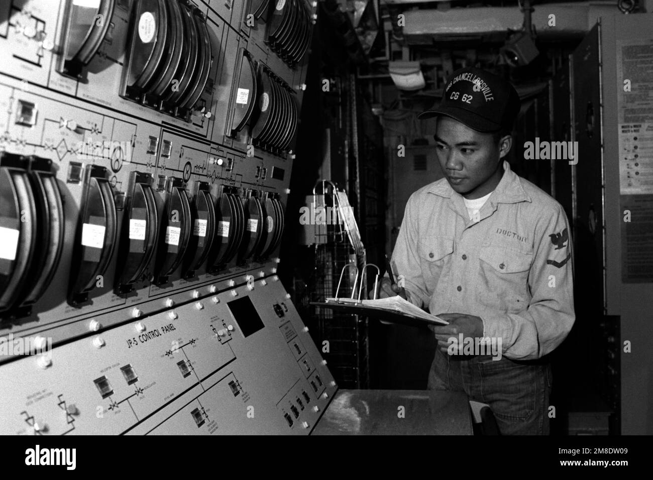 Gas Turbine Systems Technician M (Mechanical) 3rd Class John Doctor takes a reading from the fuel control panel for the engines aboard the guided cruiser USS CHANCELLORSVILLE (CG 62). Country: Unknown Stock Photo