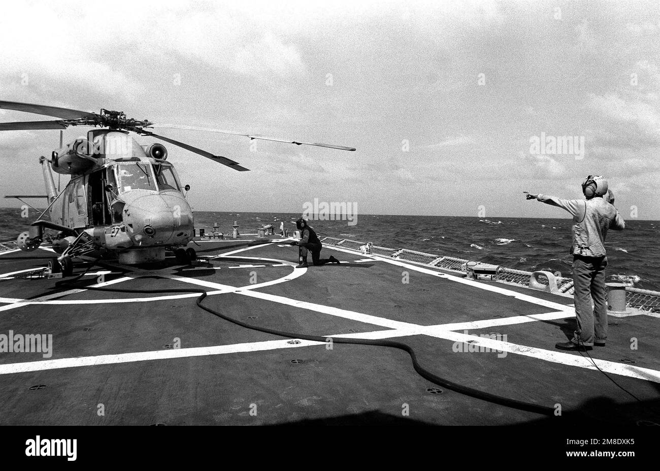 A Helicopter Light Anti-submarine Squadron 94 (HSL 94) SH-2F Seasprite helicopter refuels aboard the guided missile frigate USS CLARK (FFG 11). Country: Unknown Stock Photo