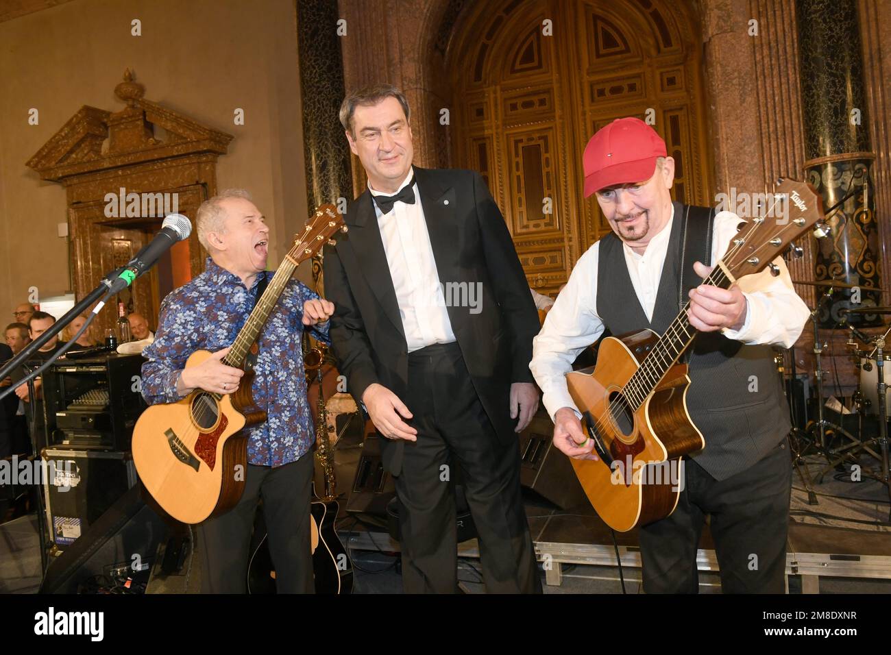 Munich, Germany. 13th Jan, 2023. Bavarian Minister President Markus Söder (CSU) (M) shows off with members of the Spider Murphy Gang, Günther Sigl (l) and Barny Murphy (r) at the Bavarian Minister President's New Year's reception at the Munich Residence. Credit: Felix Hörhager/dpa/Alamy Live News Stock Photo