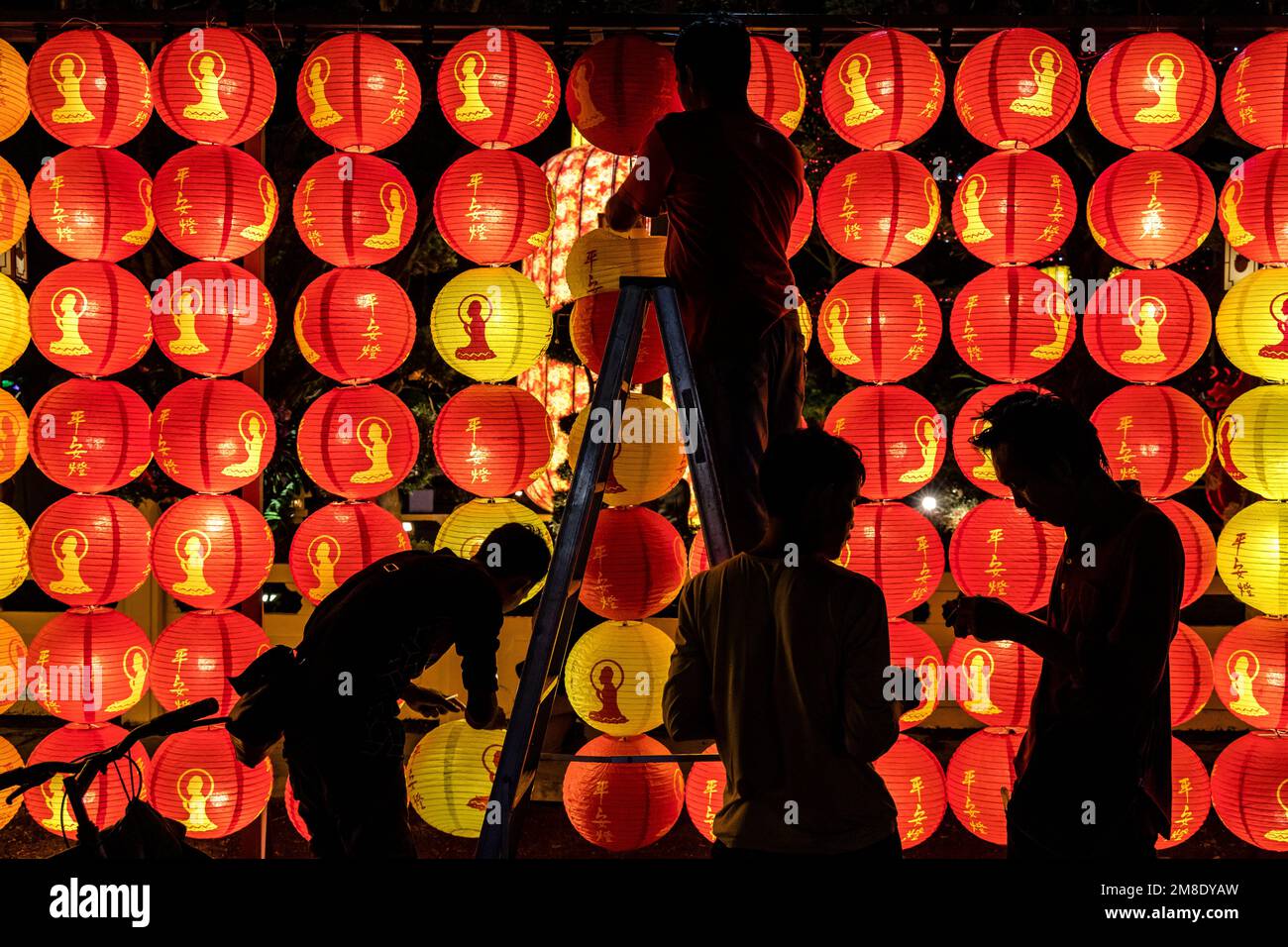 Jenjarom, Selangor, Malaysia. 13th Jan, 2023. Workers are silhouetted as they install lanterns ahead of Chinese Lunar New Year at Fo Guang Shan Dong Zen Buddhist Temple Jenjarom. (Credit Image: © Mohd Daud/ZUMA Press Wire) EDITORIAL USAGE ONLY! Not for Commercial USAGE! Stock Photo