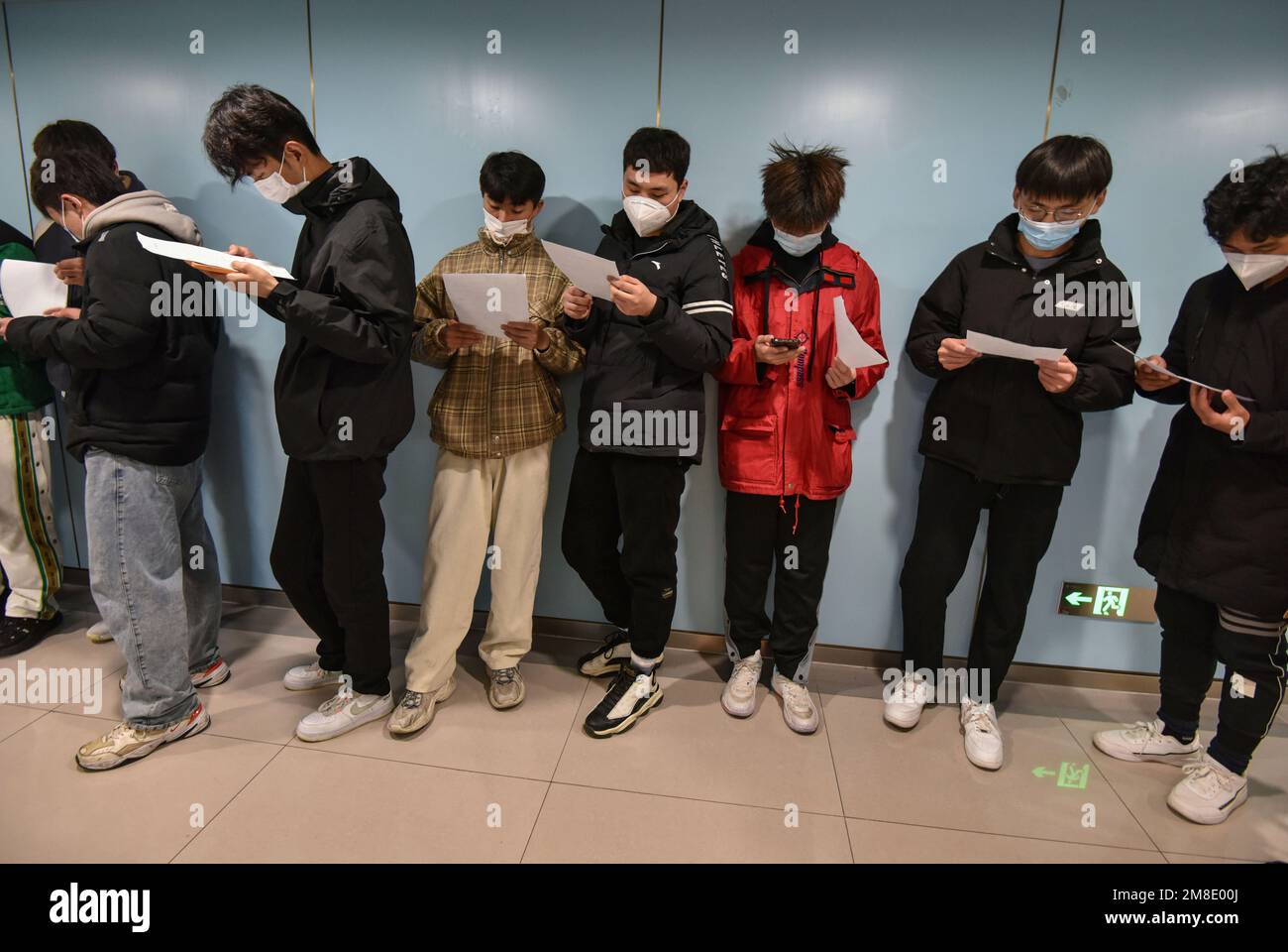 young-men-line-up-with-their-physical-examination-sheets-to-under-go-a