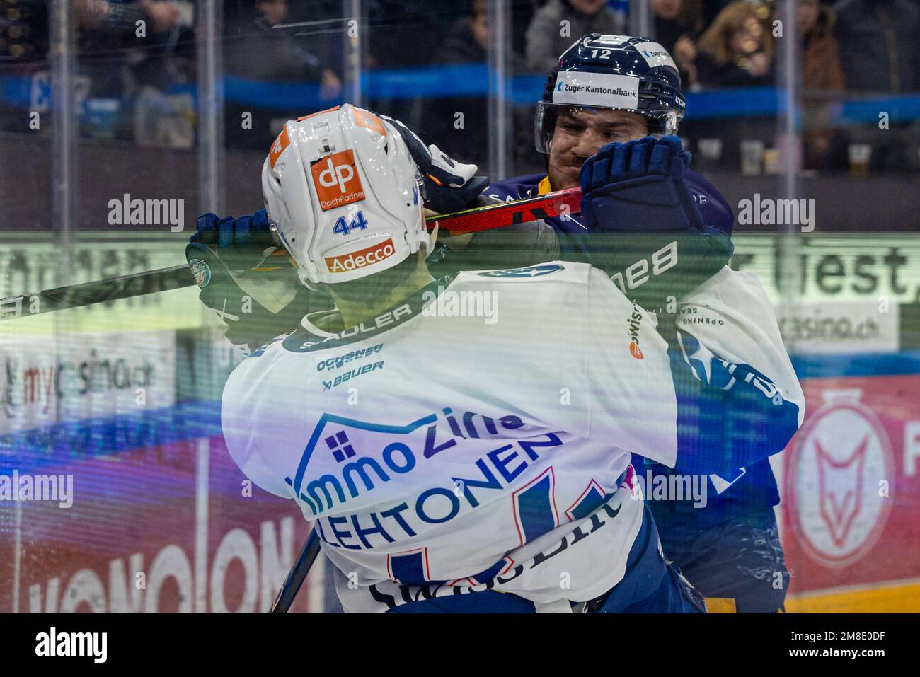 Yannick Zehnder #12 (EV Zug) clears Mikko Lehtonen #44 (ZSC Lions ...