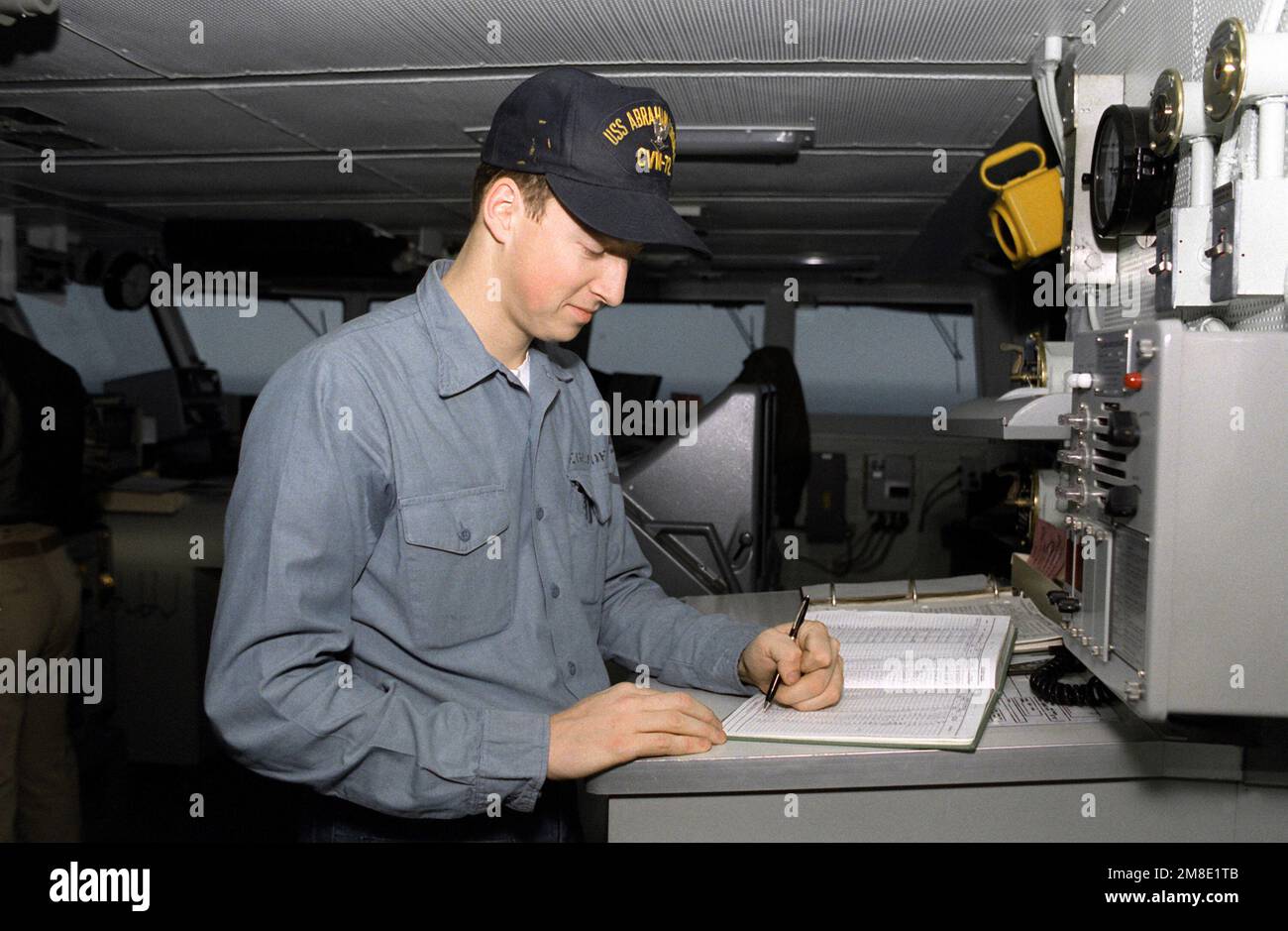 Quartermaster's Mate 3rd Class Sean Egelhoff makes an entry in the deck