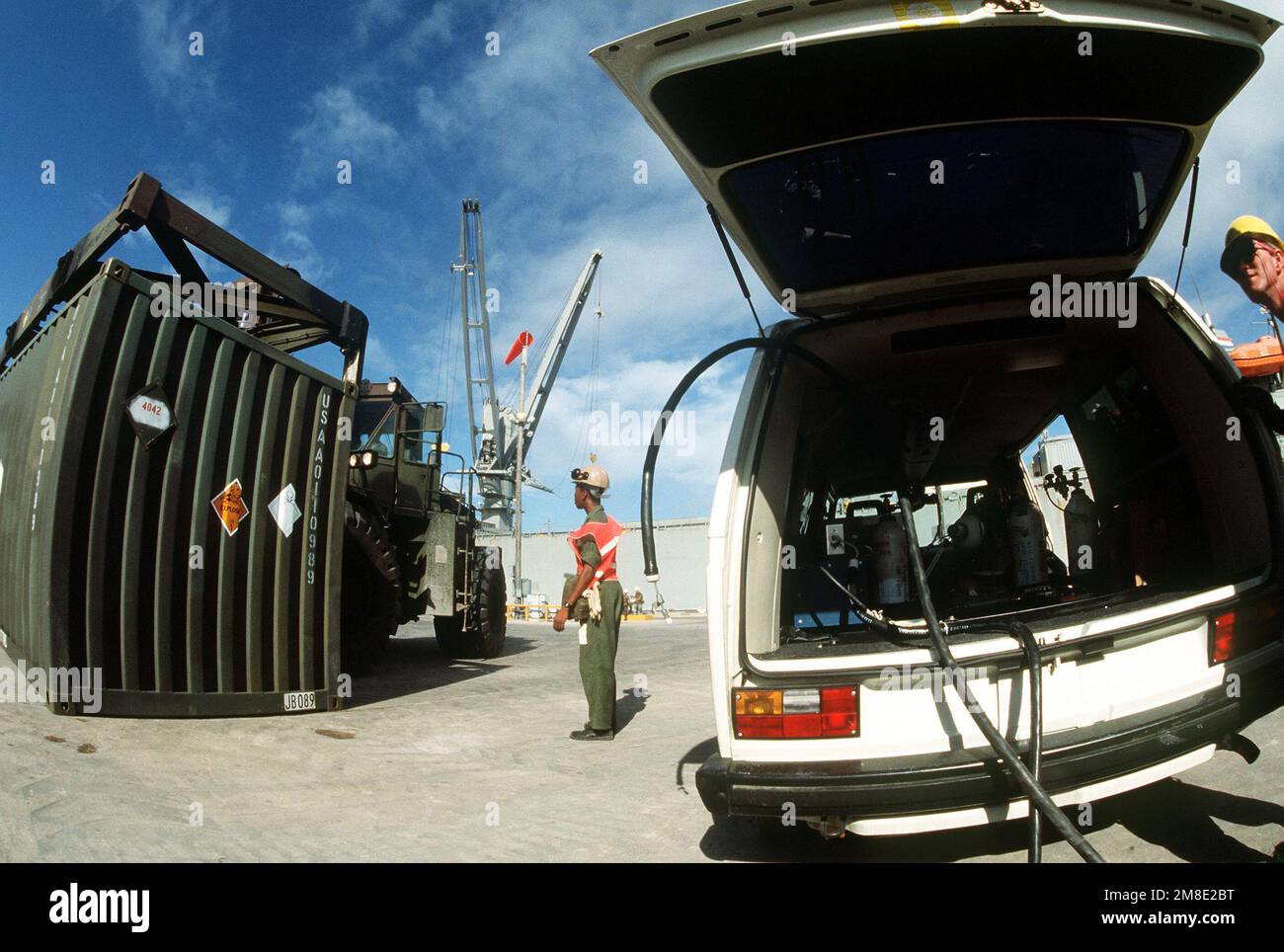 A rough terrain container handler places a container of chemical ...