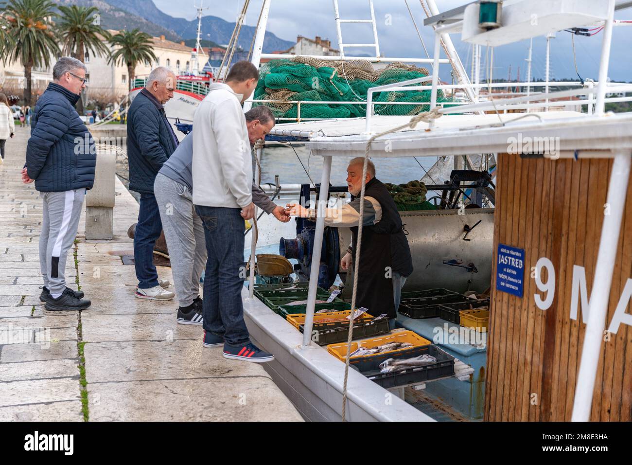 The fishmarket on Makarska embankment. Fishboat and fish. Stock Photo