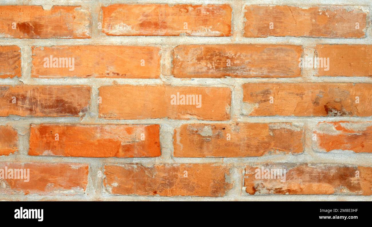 Background texture of a red brick wall with gray cement between them. Stock Photo