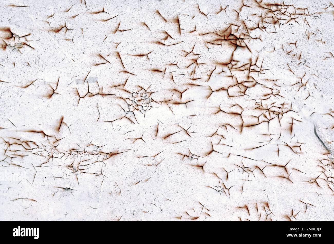 Old white paint on a rusty metal surface as a grunge texture or background. Stock Photo