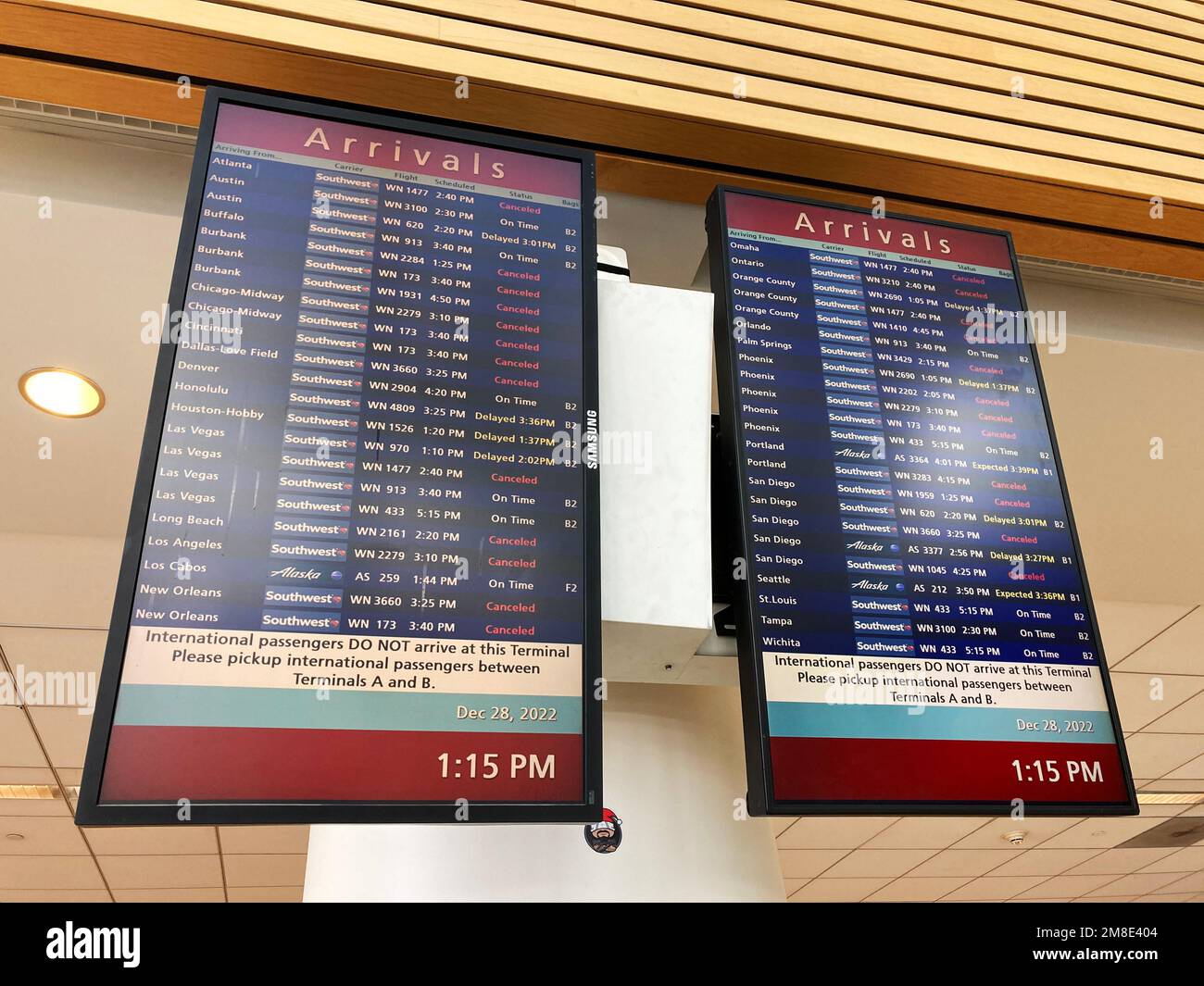 Airport arrival timetable information board displays delayed or canceled flights at San Jose International airport. - San Jose, California, USA - Dece Stock Photo