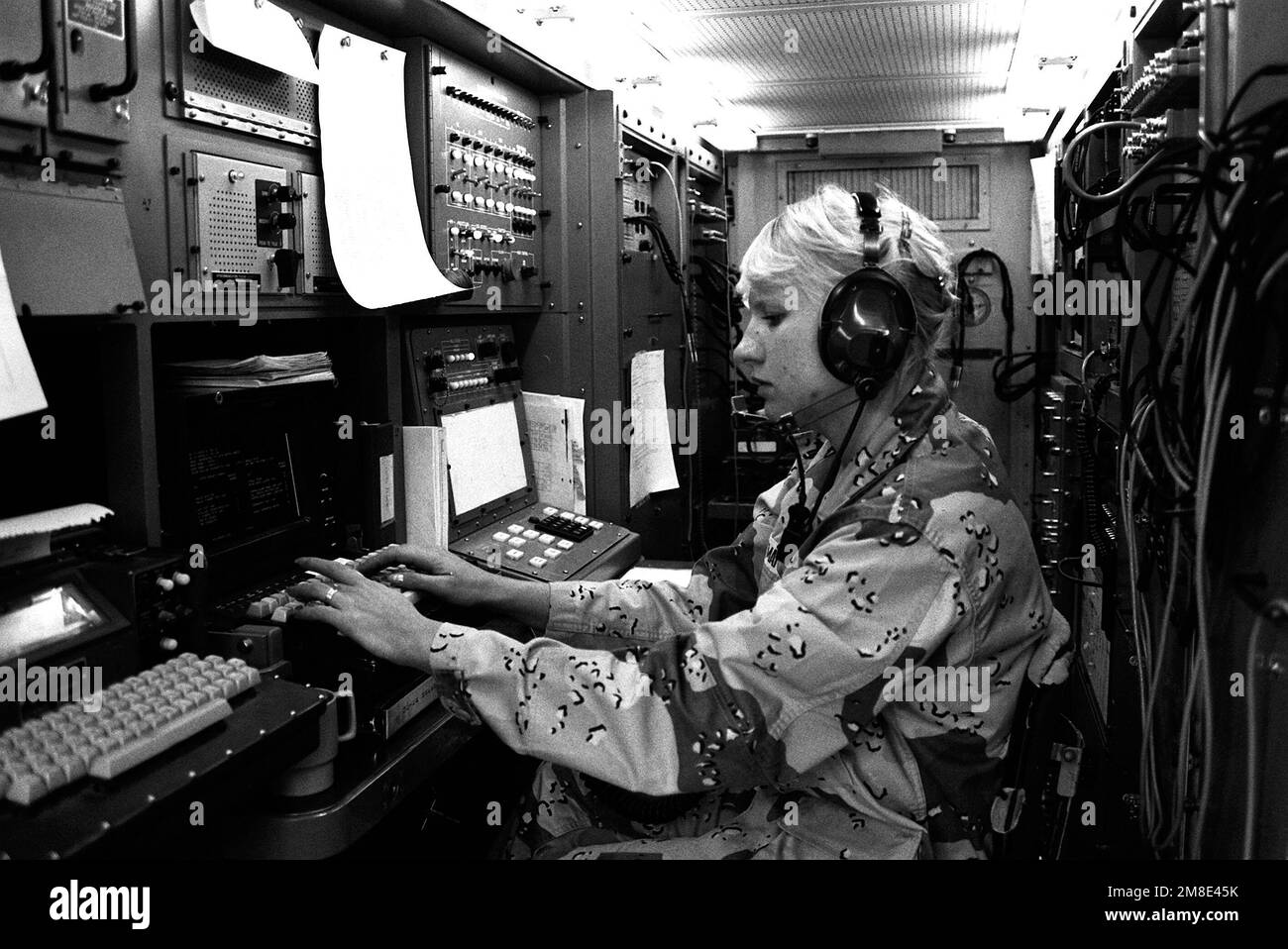 A soldier from the 11th Signal Brigade works in a telecommunications van during Operation Desert Shield. Subject Operation/Series: DESERT SHIELD Base: Riyadh Country: Saudi Arabia (SAU) Stock Photo