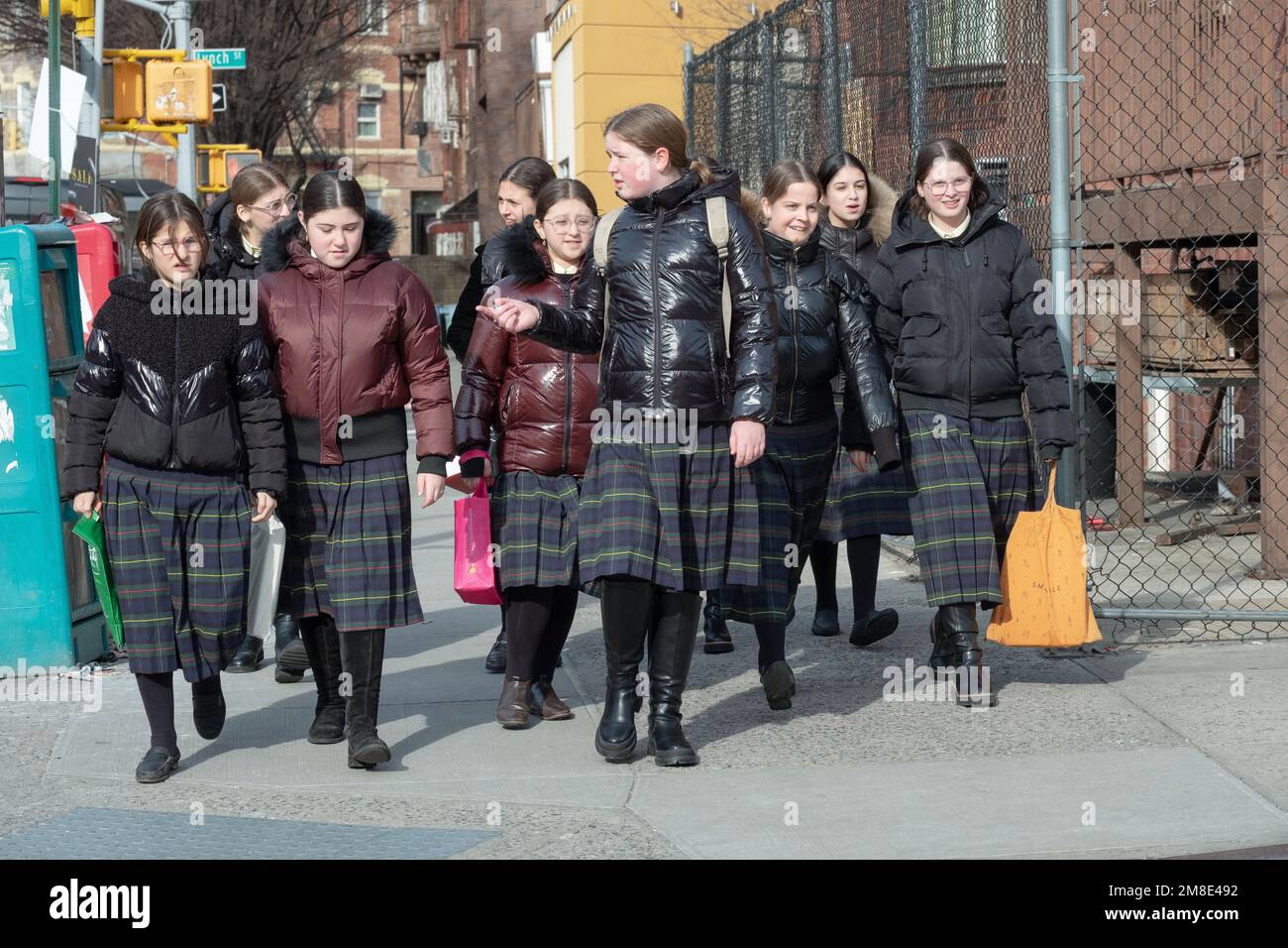 Orthodox Jewish schoolgirls wearing the same uniforms walking on Bedford Avenue in Williamsburg after classes. Stock Photo