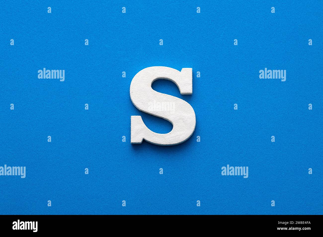 Letter S uppercase - White wood font on blue foamy background Stock Photo