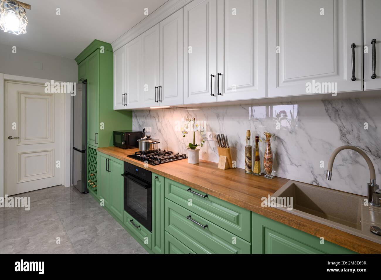 Green and white colored modern kitchen detail Stock Photo