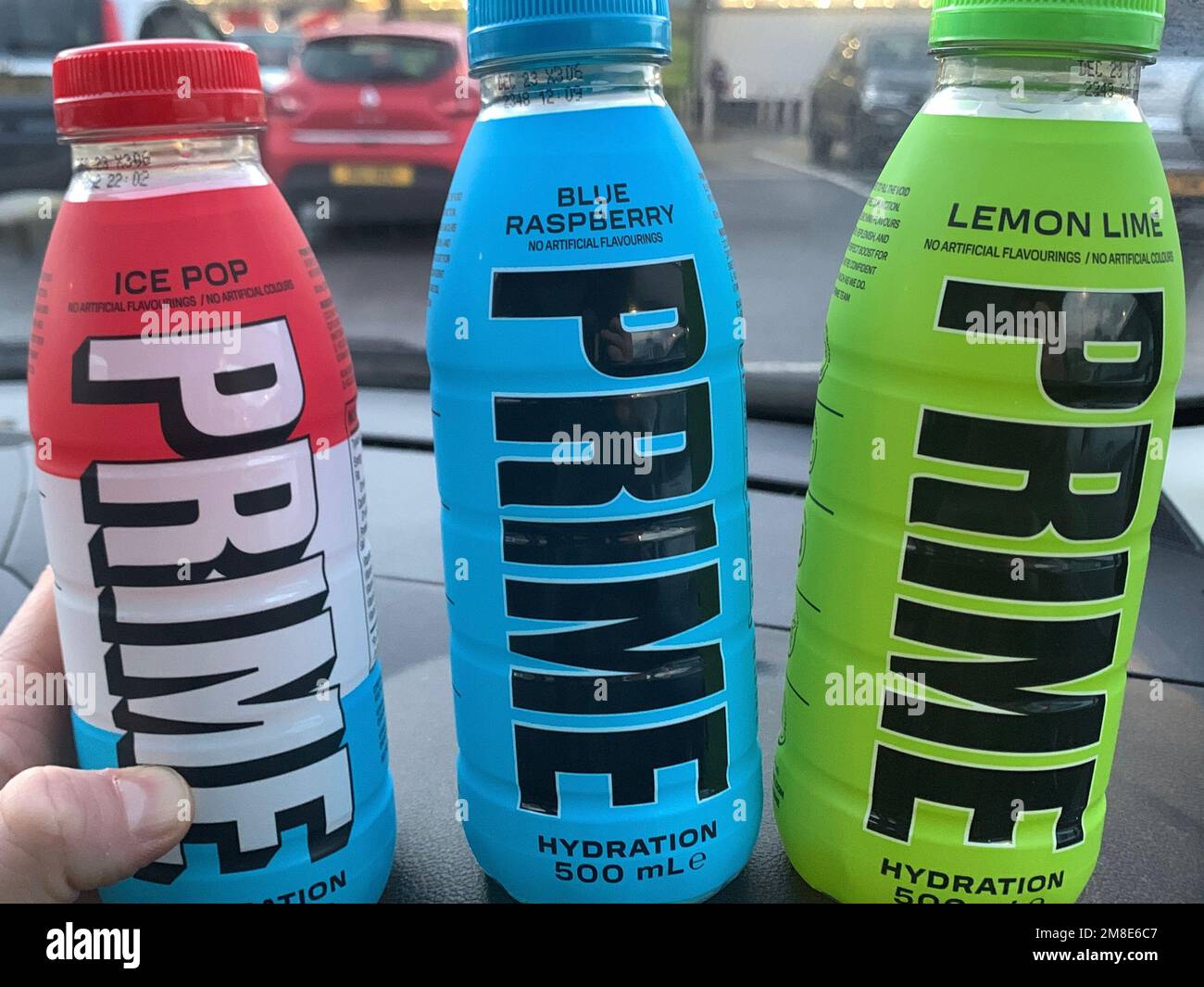 Hand holding a bottle of Prime hydration energy drink Stock Photo - Alamy
