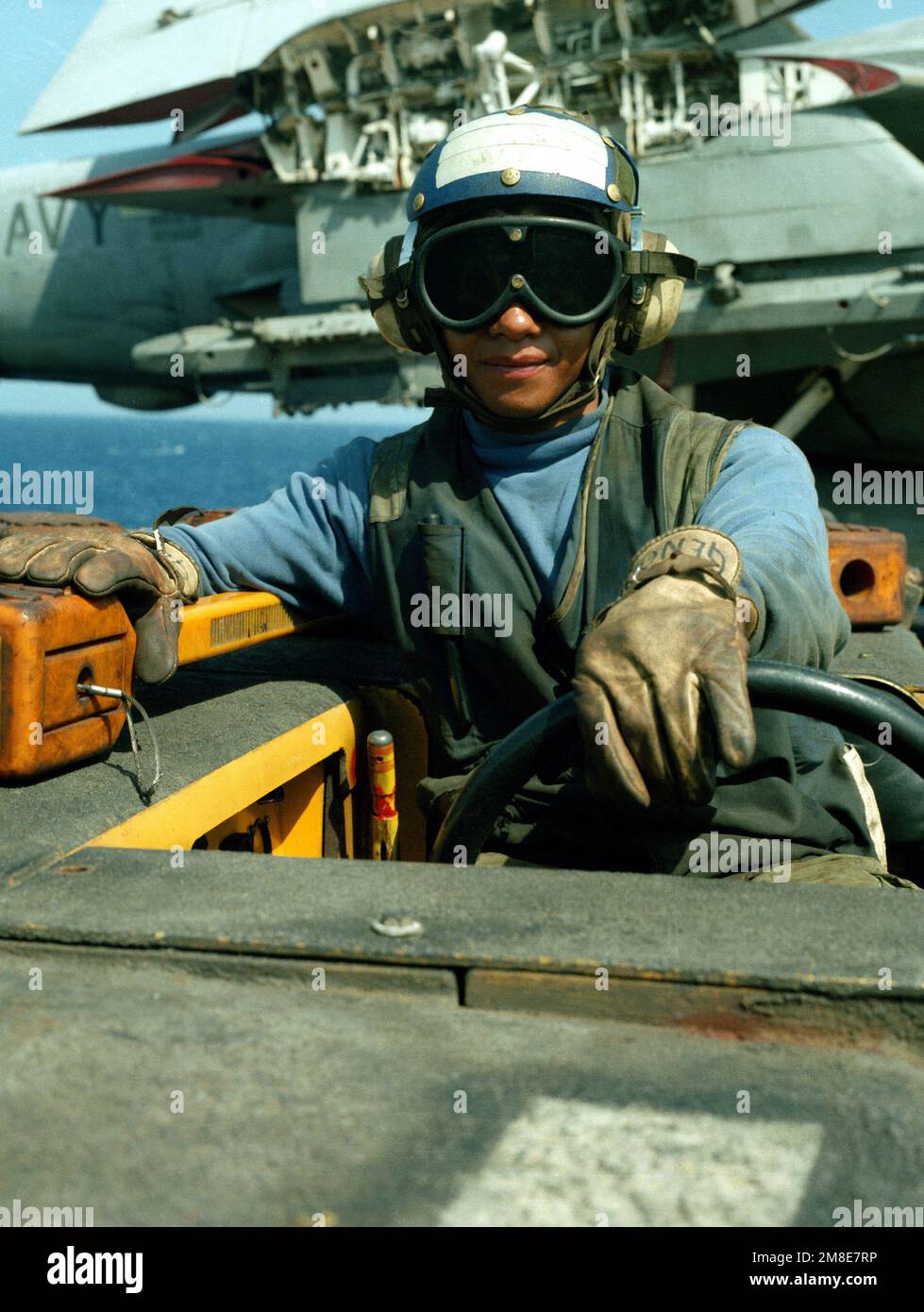 ARM Genovevo Maya sits behind the wheel of an MD-3A tow tractor on the ...