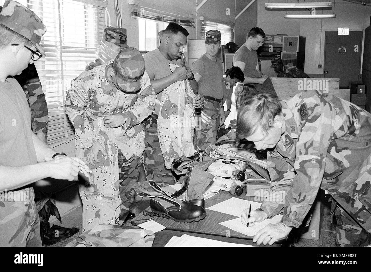 Soldiers from the 6th Signal Brigade receive their issue of desert clothing and equipment from 11th Signal Brigade supply personnel. The 6th Signal Brigade is preparing to deploy to Saudia Arabia for OPERATION DESERT SHIELD. Subject Operation/Series: DESERT SHIELD Base: Fort Huachuca State: Arizona (AZ) Country: United States Of America (USA) Stock Photo