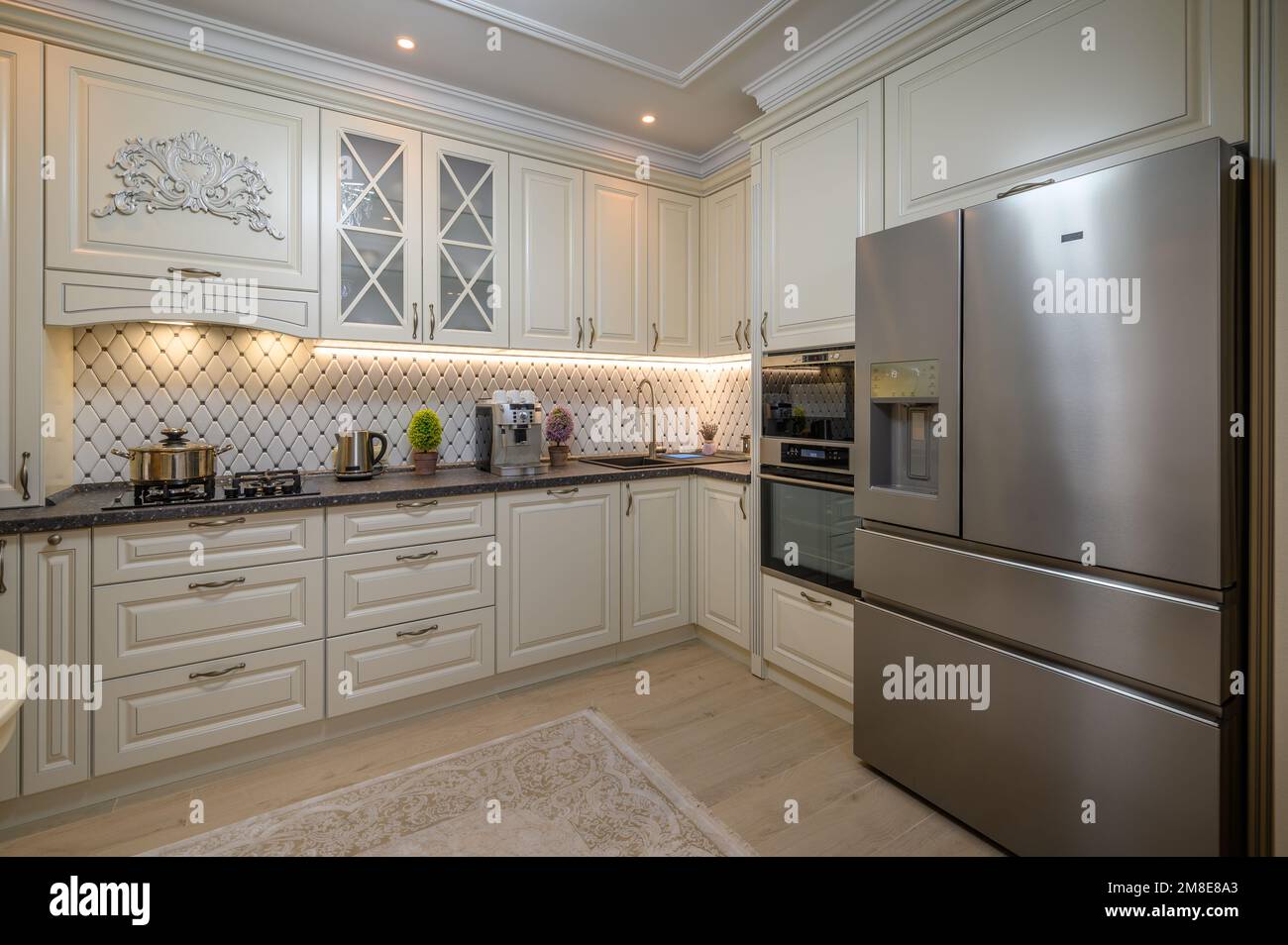 Classic beige kitchen with counter space and a variety of appliances ...