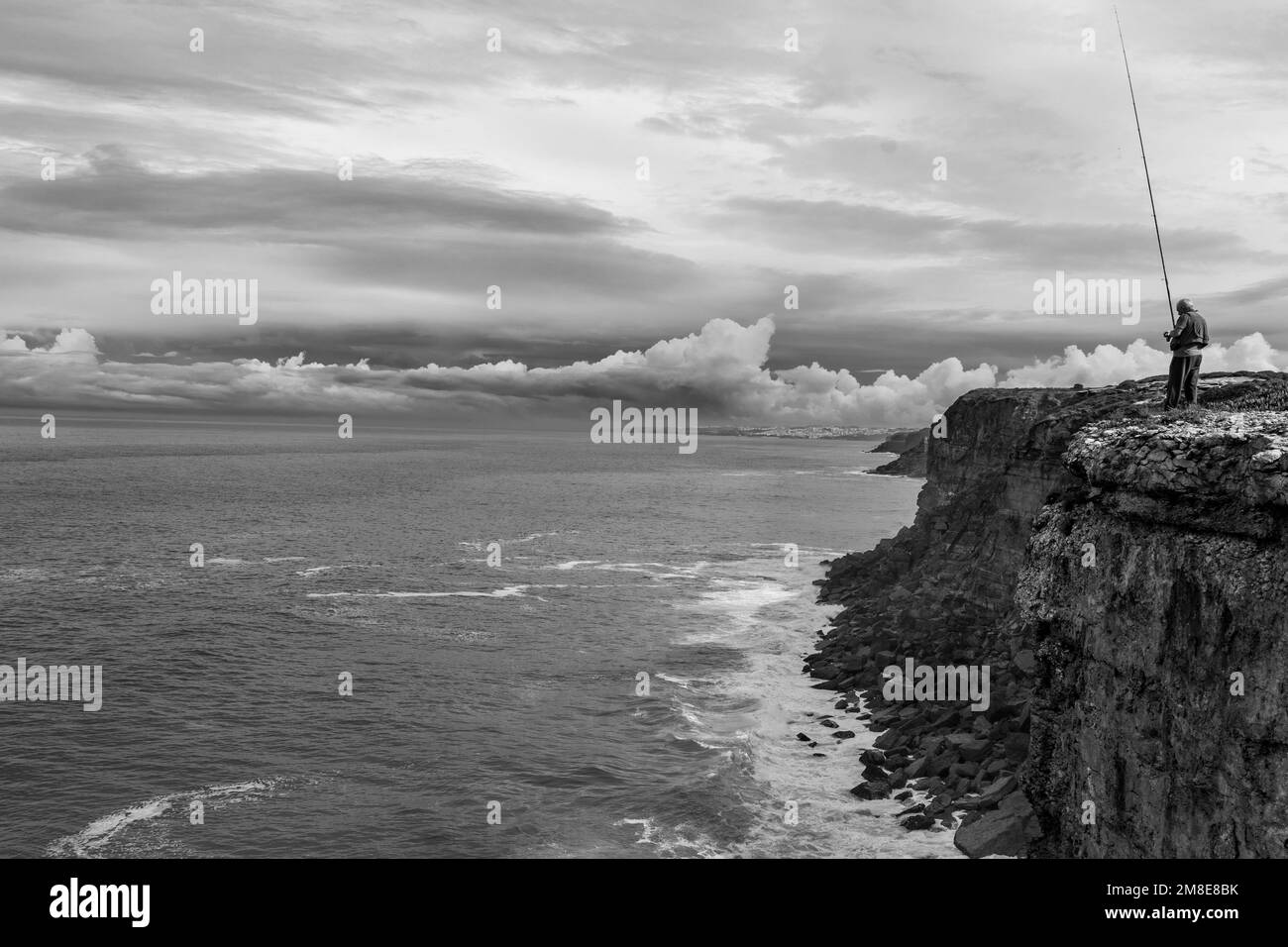 Person sea fishing from Black and White Stock Photos & Images - Alamy
