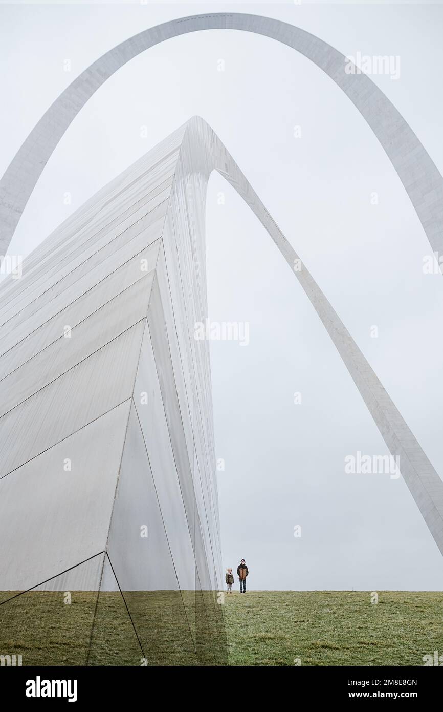 Multiple exposure of kids standing under St. Louis Gateway Arch Stock Photo